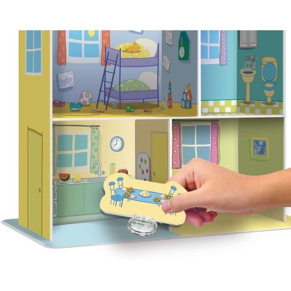 Die Hand eines Kindes, die einen Tisch in ein Puppenhaus mit bemalten Zimmern stellt.