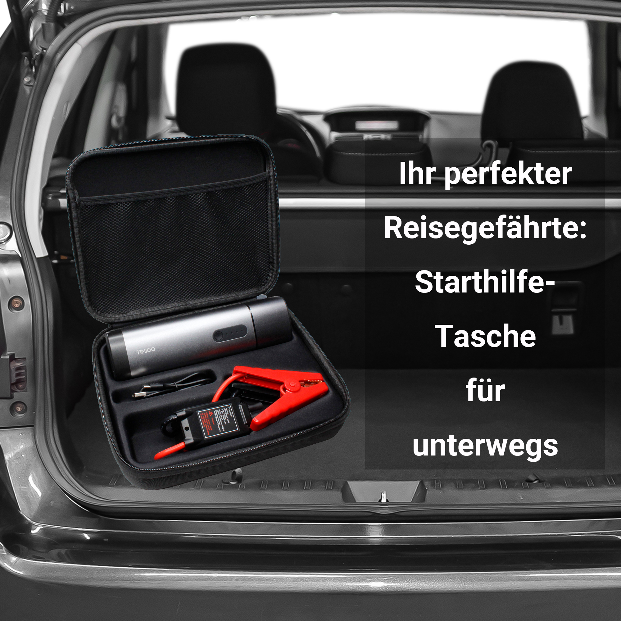 Ein schwarzer Koffer mit Starthilfe und anderen Werkzeugen im Kofferraum eines Autos.