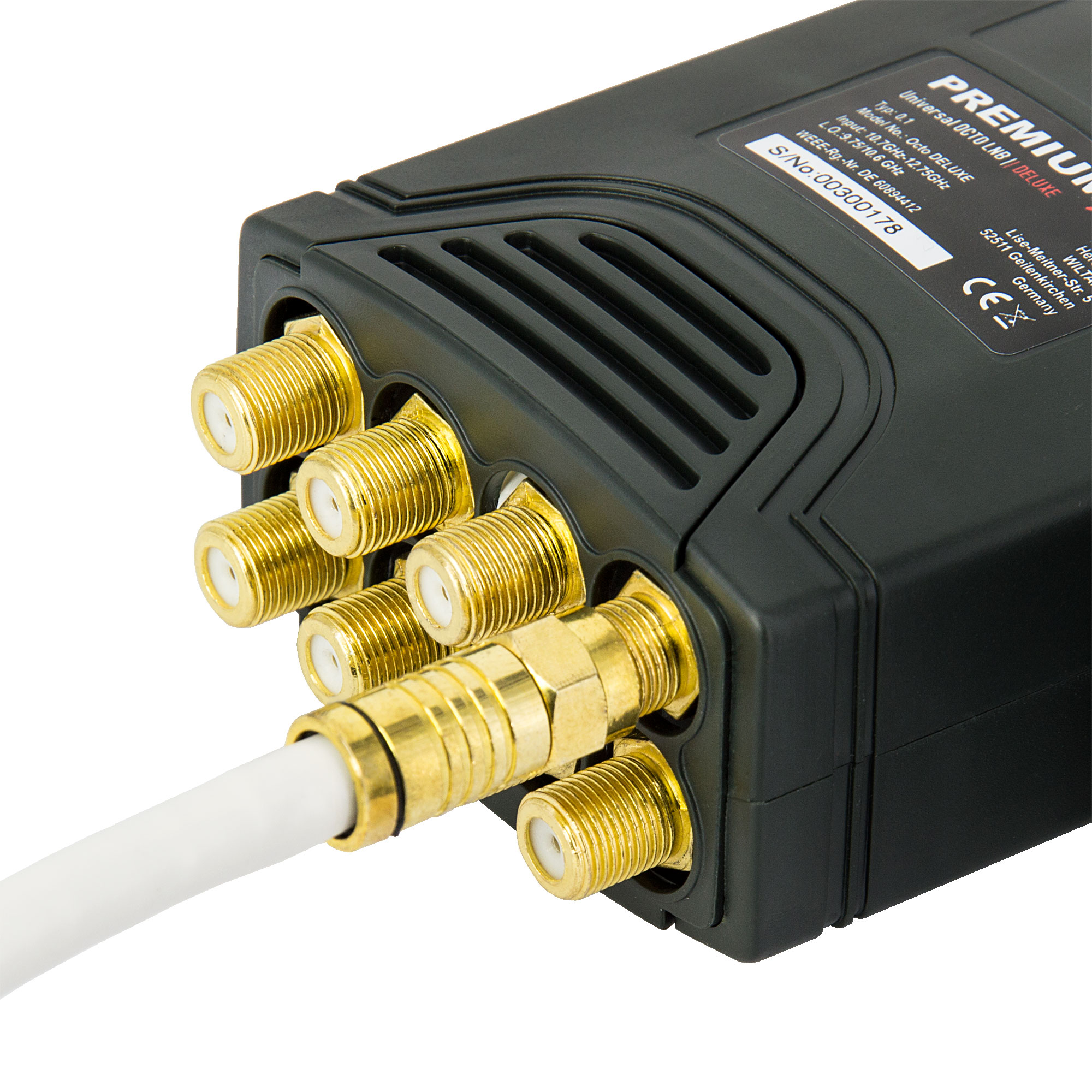 Ein schwarzes elektronisches Gerät mit mehreren goldfarbenen Anschlüssen und einem weißen Kabel.