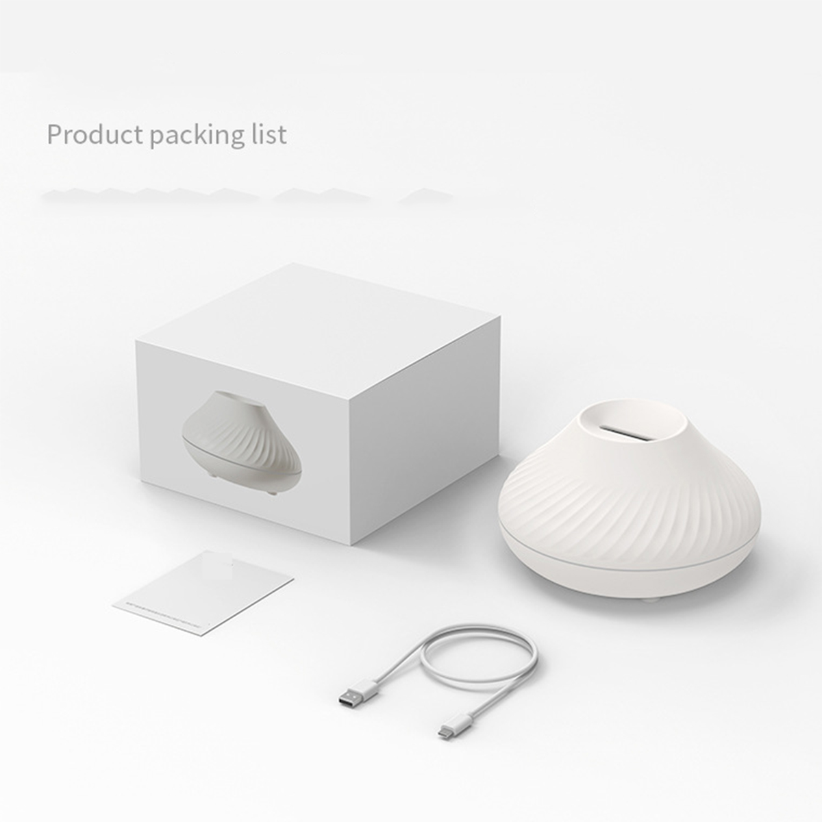 Weiße Produktverpackung, kleines weißes Gerät und ein Ladekabel.