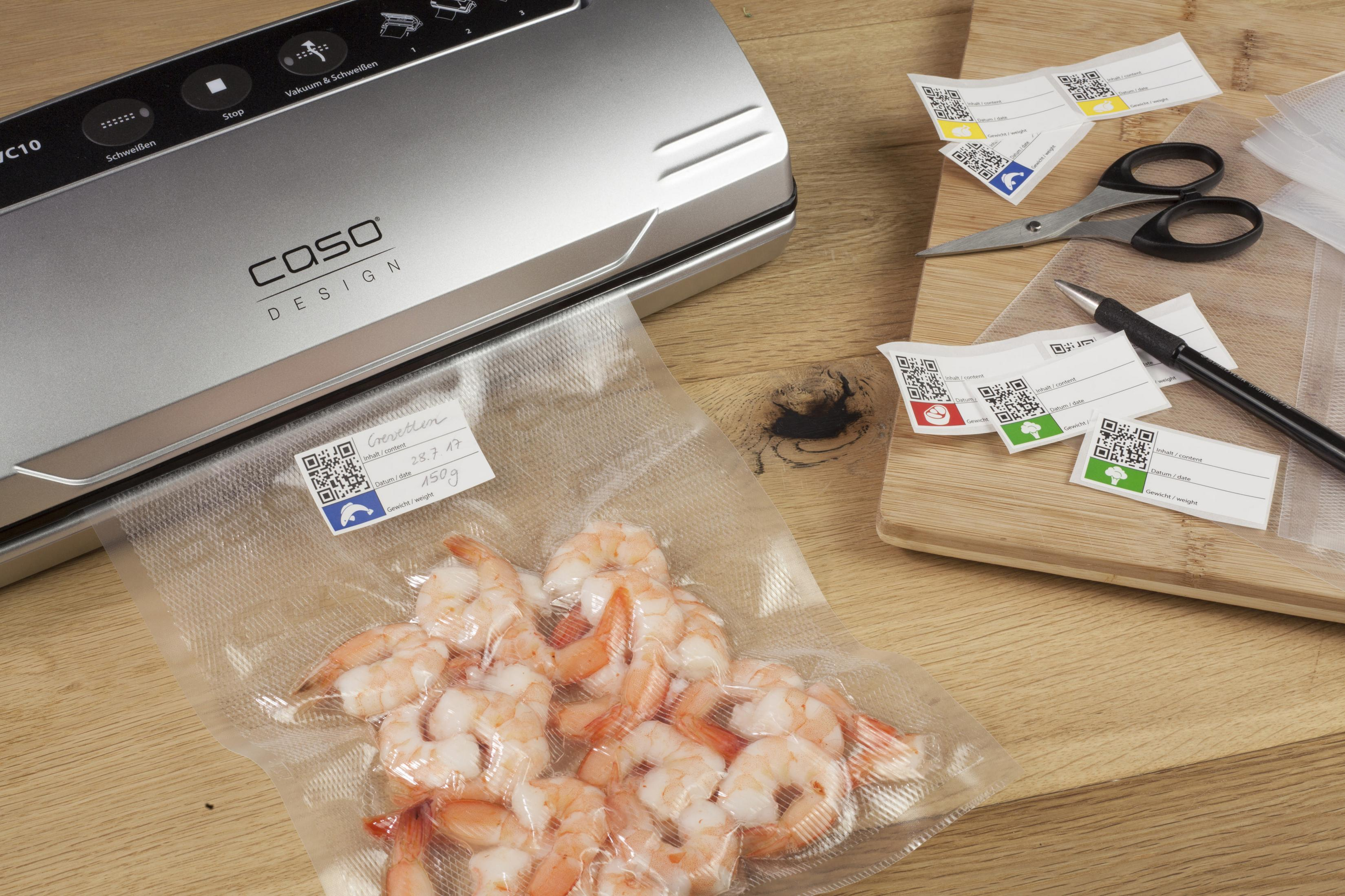 Vacuum sealer with shrimp in a bag and labels on a wooden board.