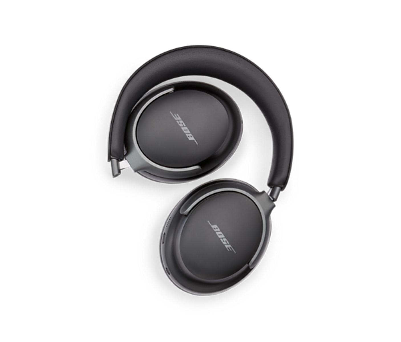 Ciemnoszare słuchawki Bose, złożone, na czarnym tle. Widoczne logo Bose.