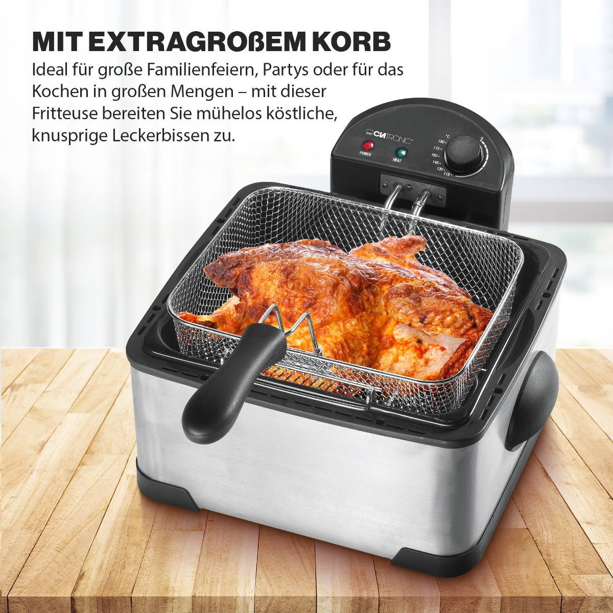 Frytownica z kurczakiem w środku. Stal nierdzewna, czarny uchwyt, na drewnianej powierzchni.