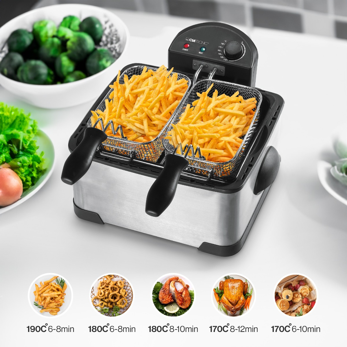 Frytownica ze stali nierdzewnej z dwoma koszami wypełnionymi frytkami. Zawiera sugestie dotyczące temperatury gotowania.