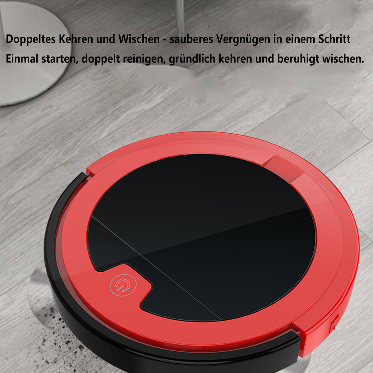 Ein roter und schwarzer Roboter-Staubsauger auf einem grauen Boden. Das Gerät ist rund.