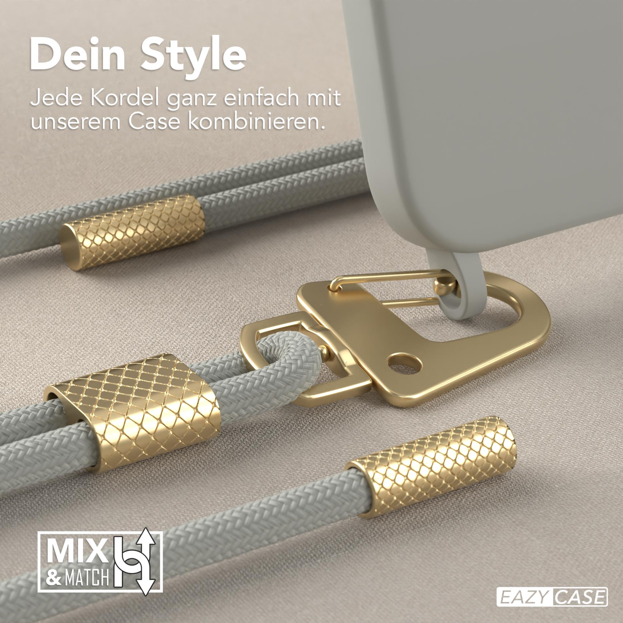 Nahaufnahme einer Handyhülle mit goldenem Verschluss, grauem Seil und goldenen Akzenten, auf beigem Hintergrund.