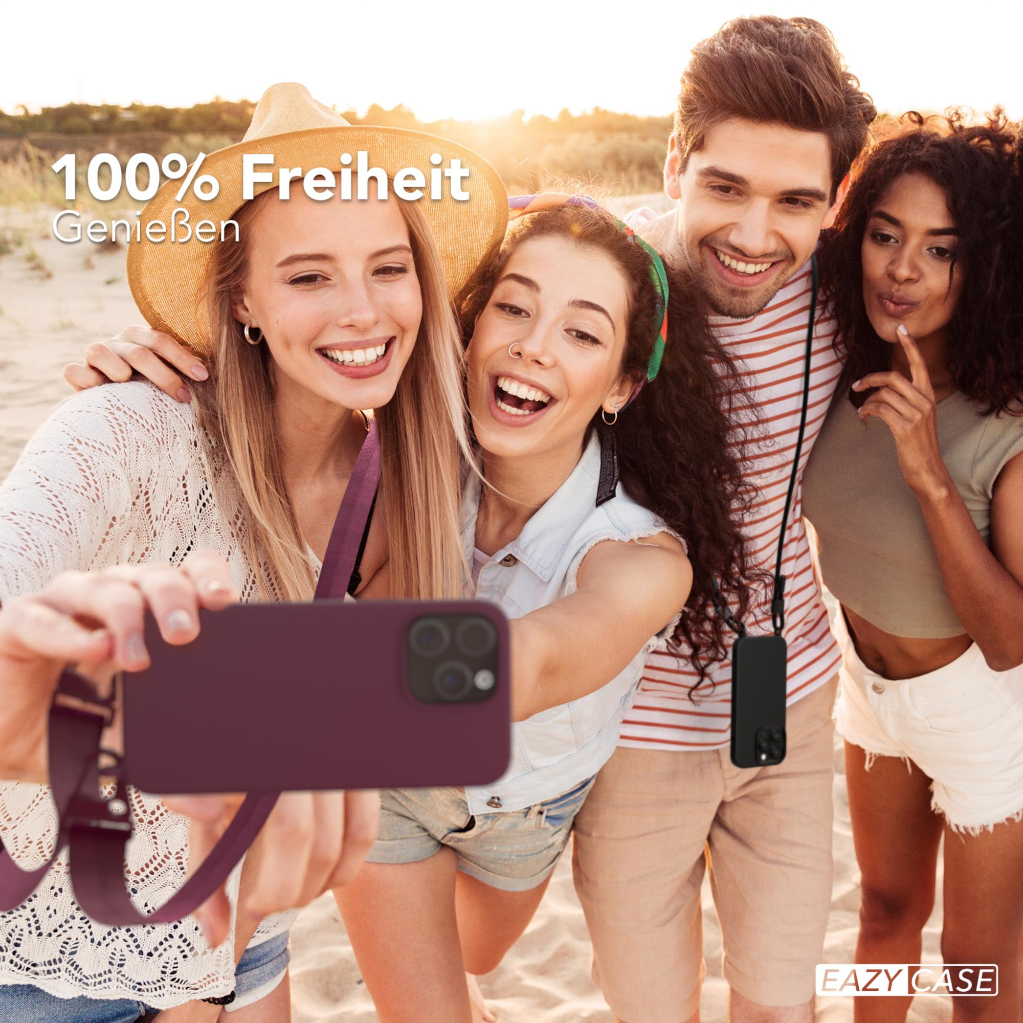 Ein Telefon in einer roten Hülle mit einem Ladegerät darüber.