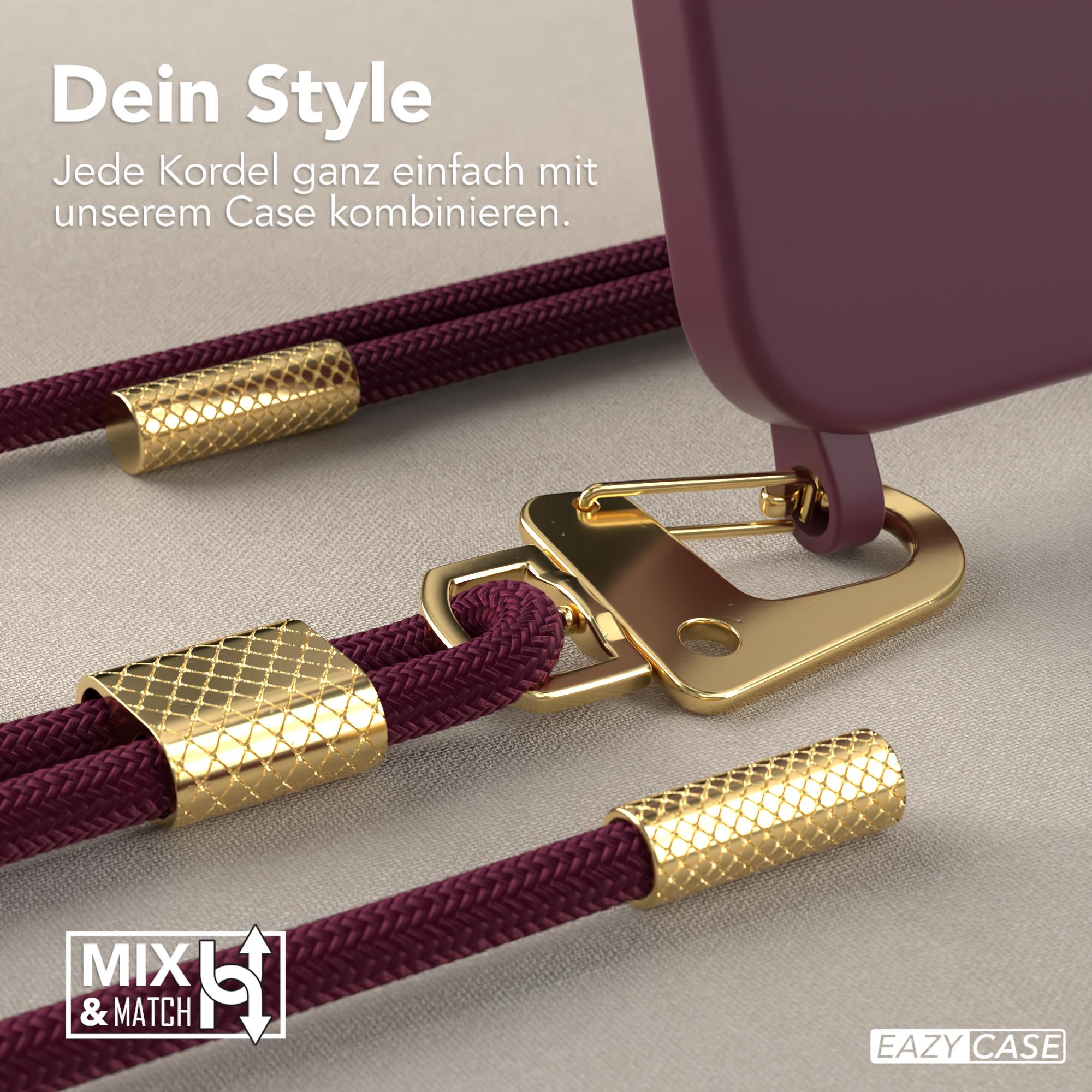 Nahaufnahme von Handyhülle und Kordel mit goldenen Akzenten. Die Kordel ist bordeauxfarben.