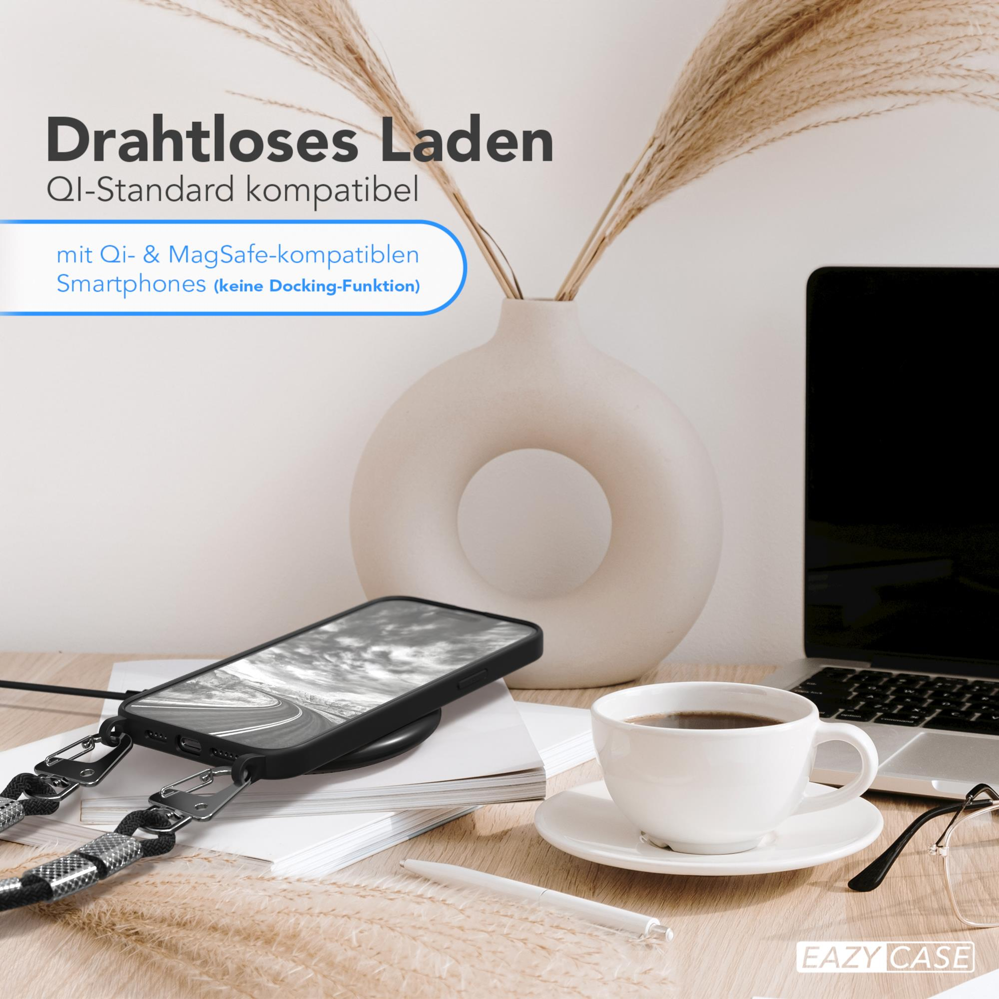 Ein Telefon, das drahtlos auf einem Schreibtisch neben einer Kaffeetasse aufgeladen wird.