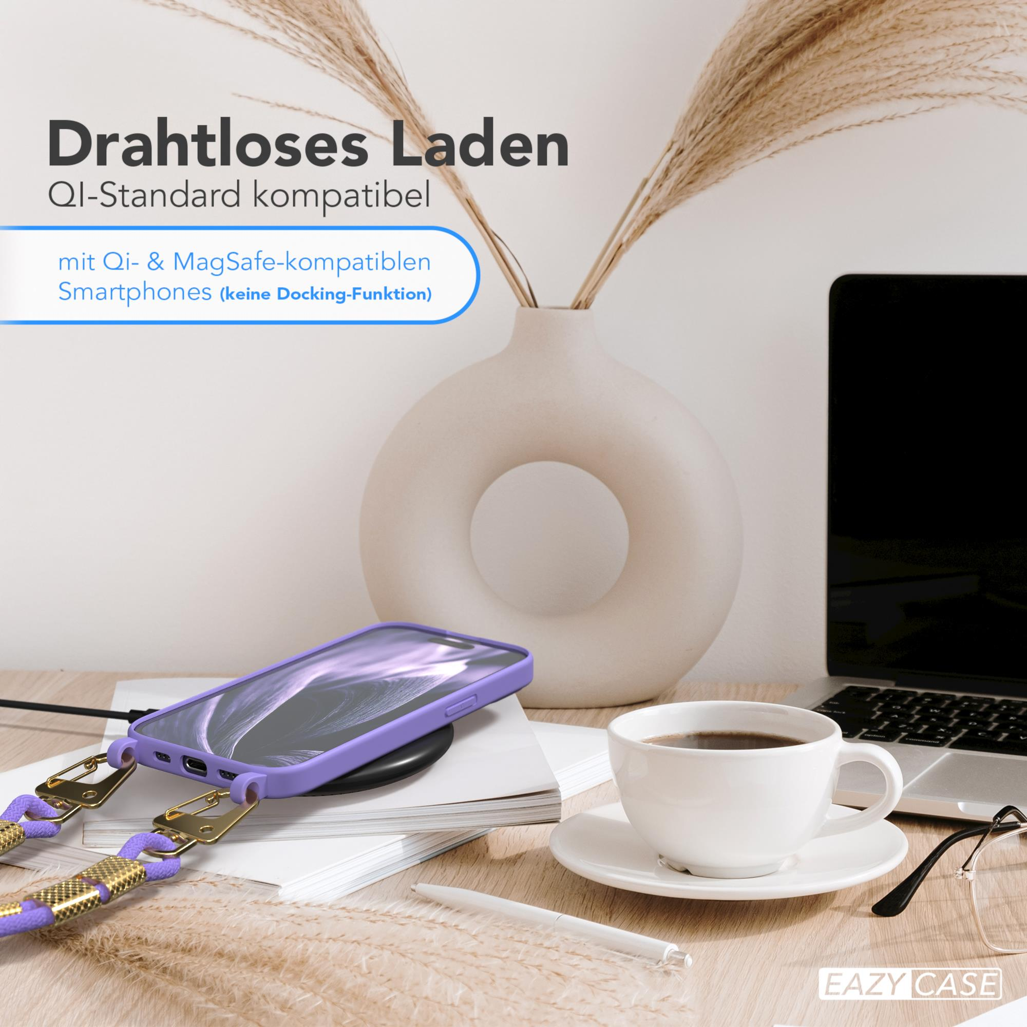 Ein Telefon auf einem kabellosen Ladegerät, mit einer Kaffeetasse und einem Laptop.