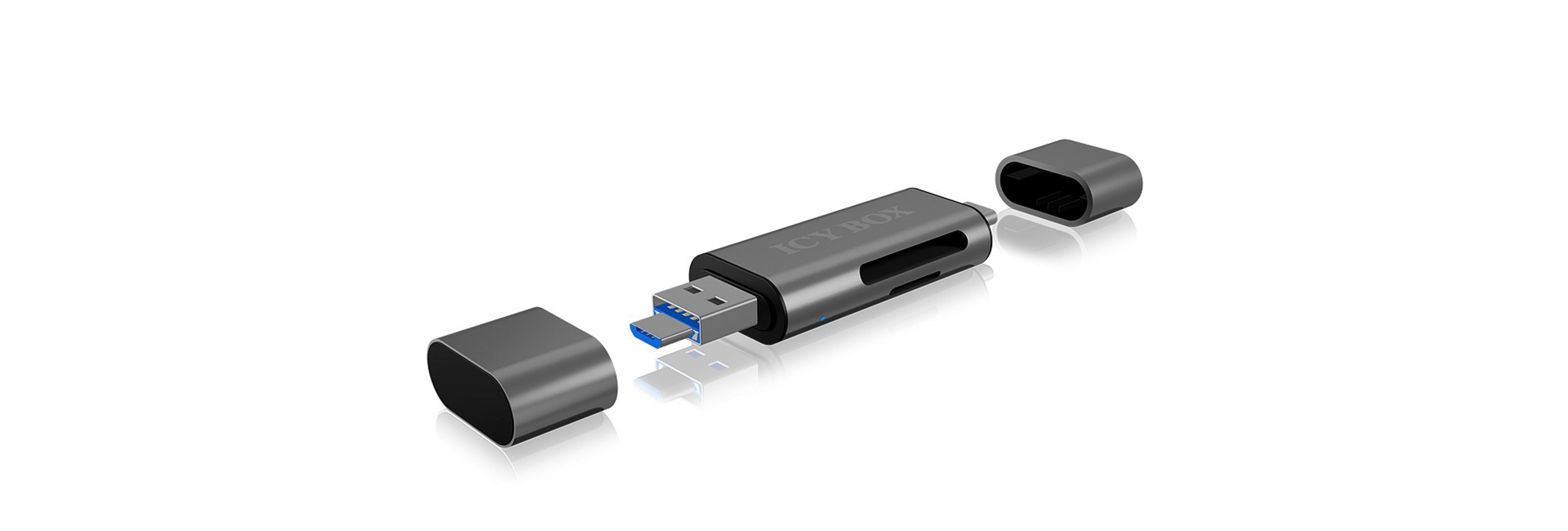 Srebrny pendrive z obydwoma zaślepkami zdjętymi, odsłaniający złącza USB i micro USB.