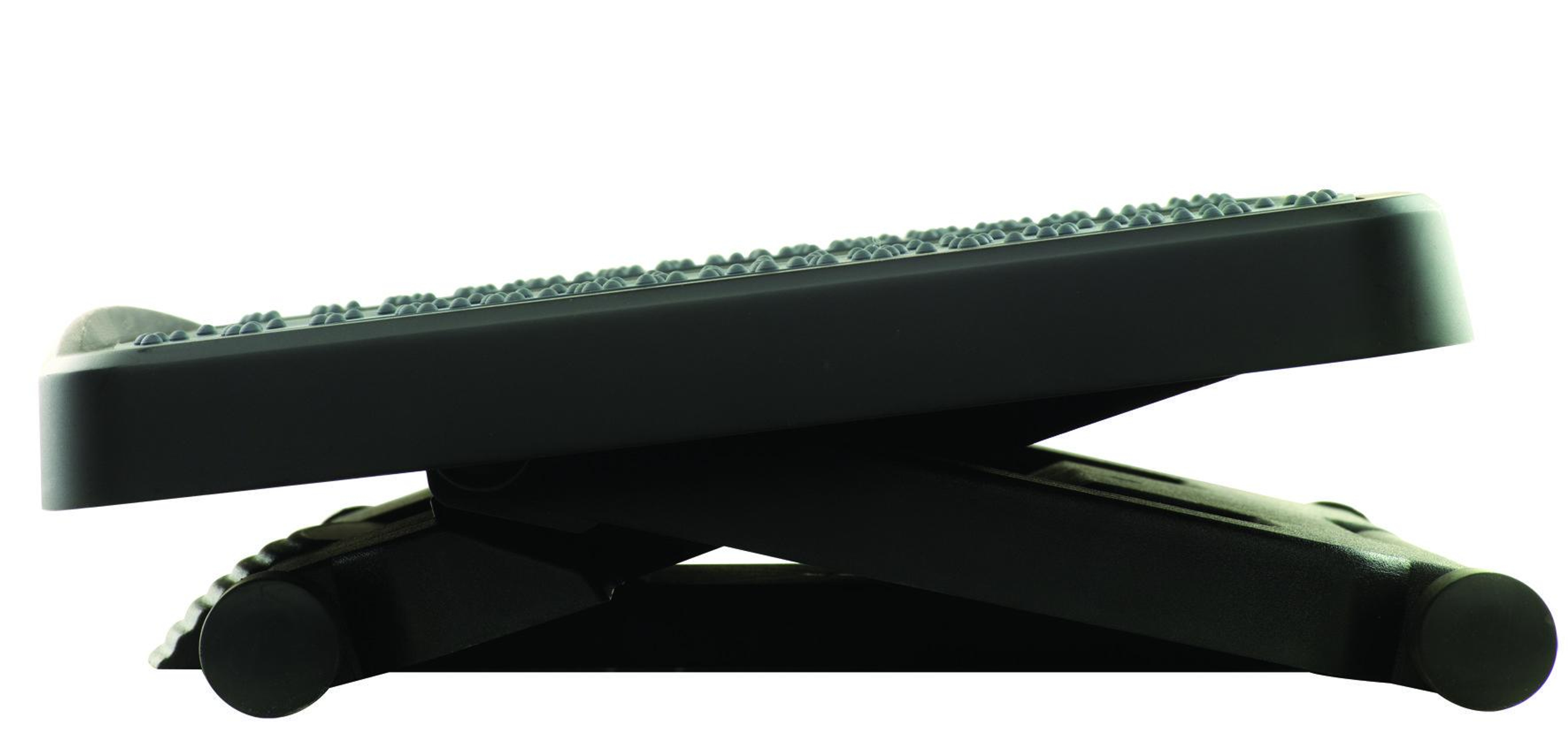 Black footrest, angled, with a textured surface and a supportive base.