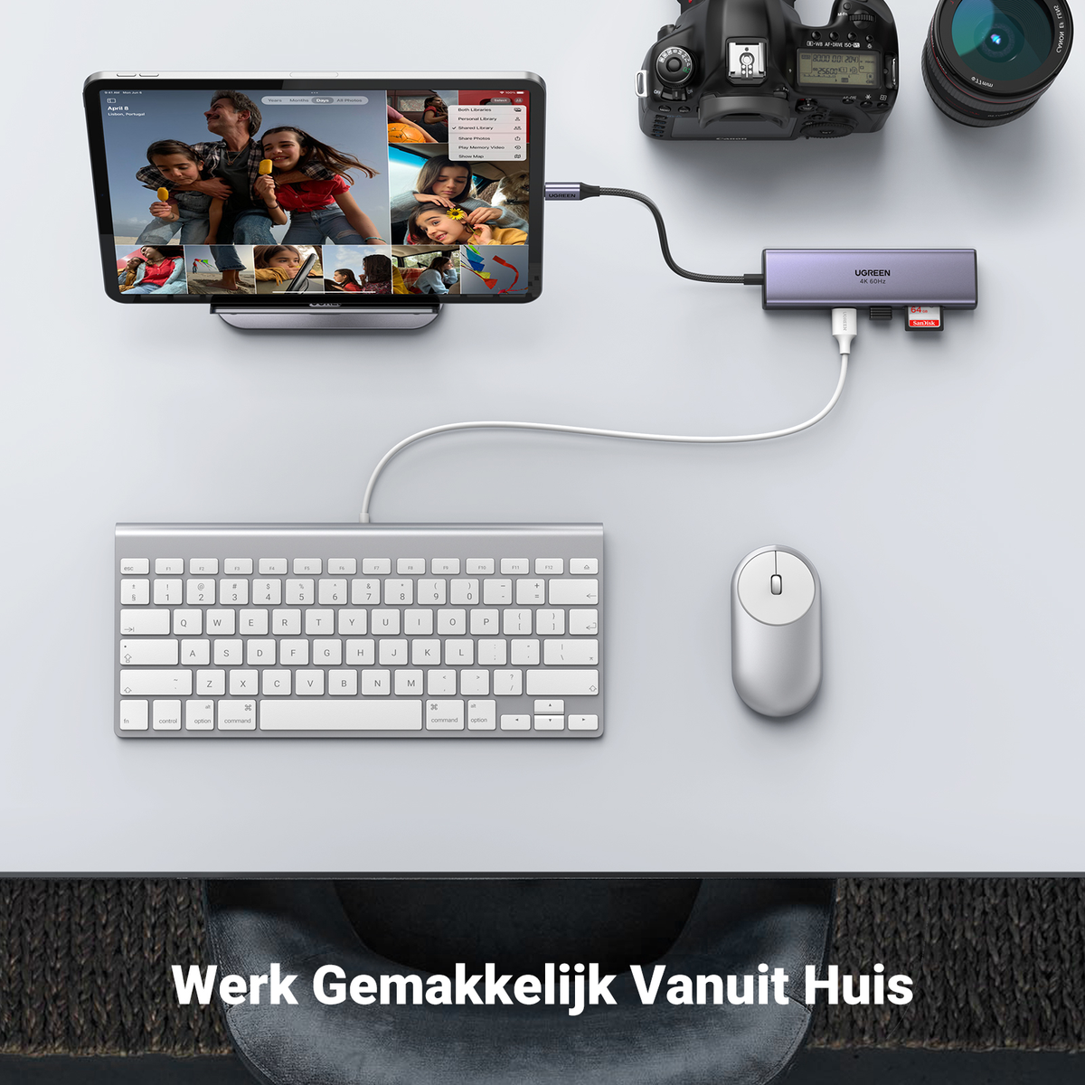 Tableta, teclado, ratón y cámara en un escritorio blanco, conectados a un concentrador. El texto "Werk Gemakkelijk Vanuit Huis".