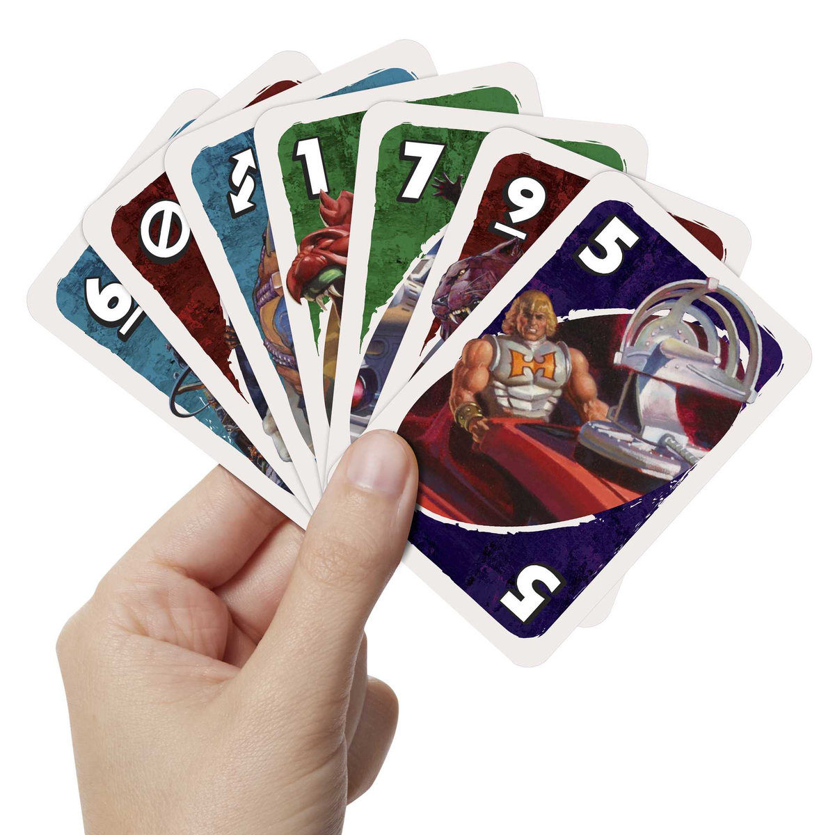 Main tenant des cartes Uno en éventail avec des personnages de Masters of the Universe.