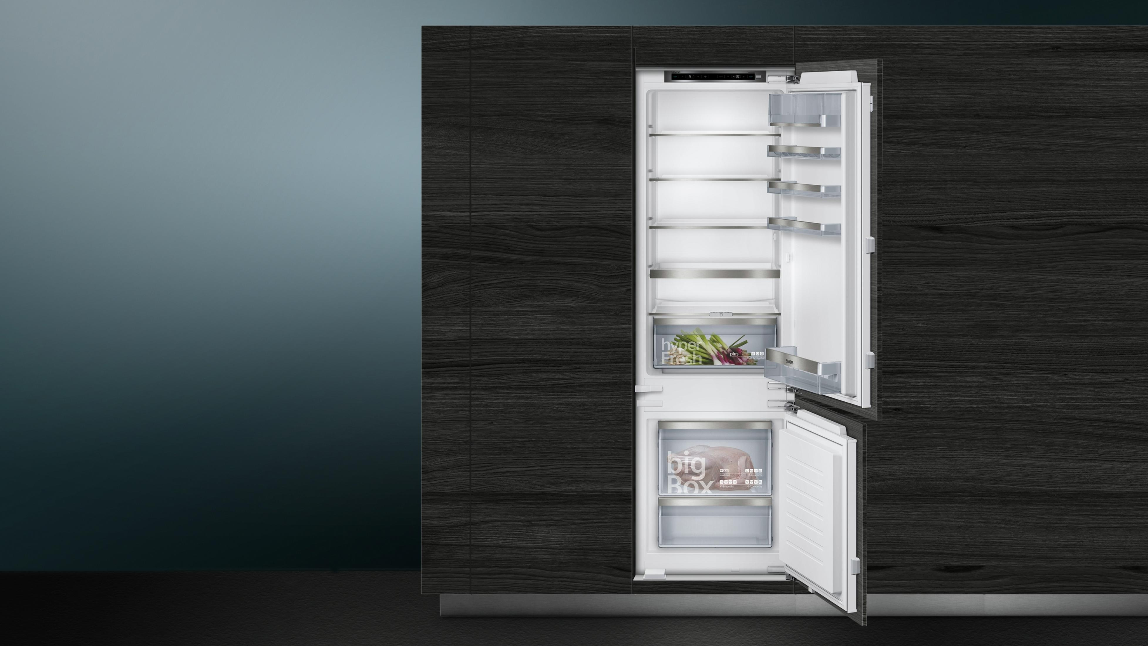 Ein Kühlschrank mit offenen Türen, der Regale, Schubladen und ein Gefrierfach zeigt.