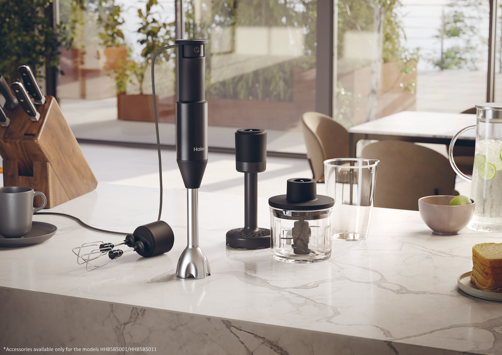A kitchen counter with a blender and accessories. Includes a jug and a coffee cup.