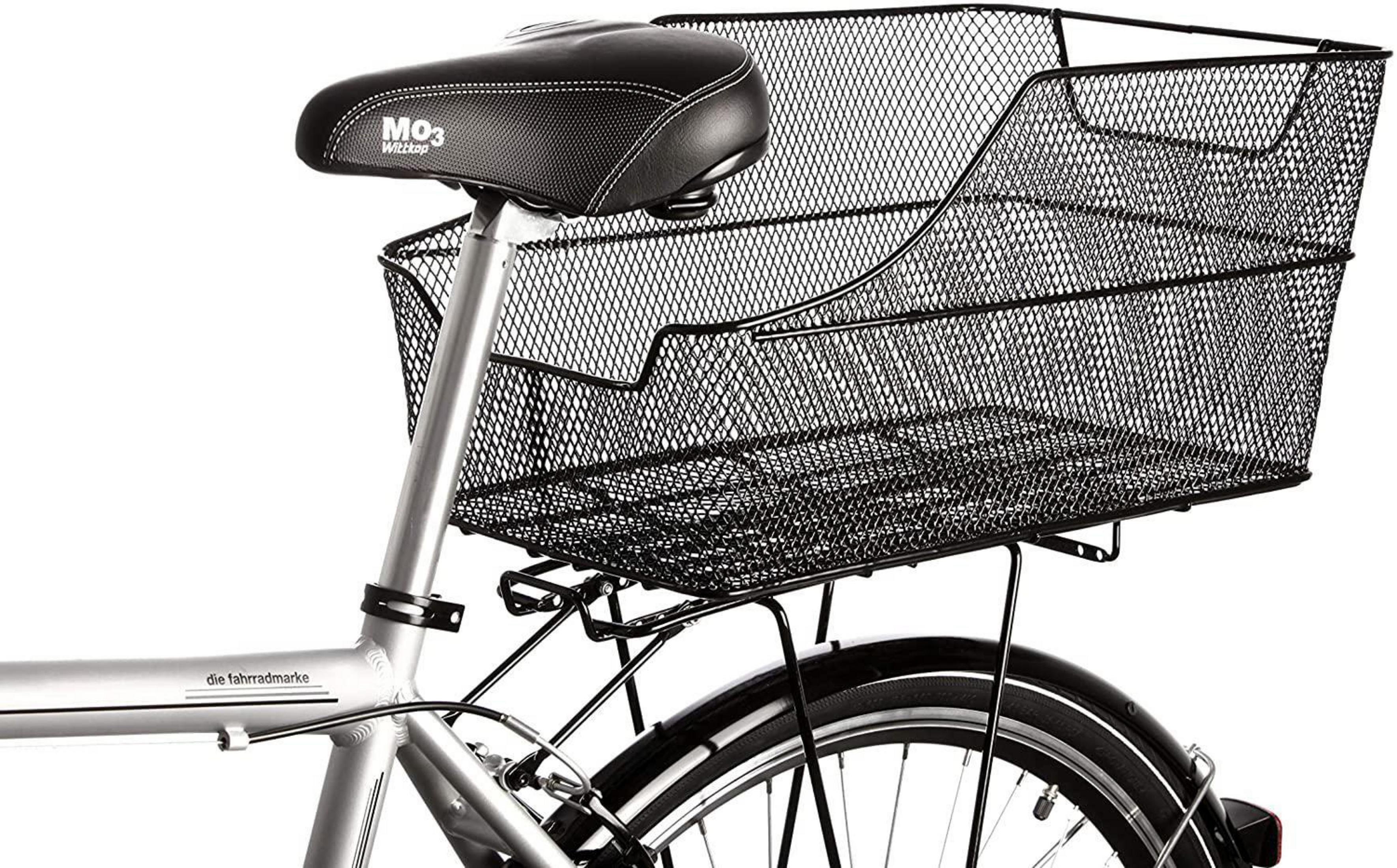 Tył roweru z czarnym koszem drucianym, siodełkiem i częścią ramy.