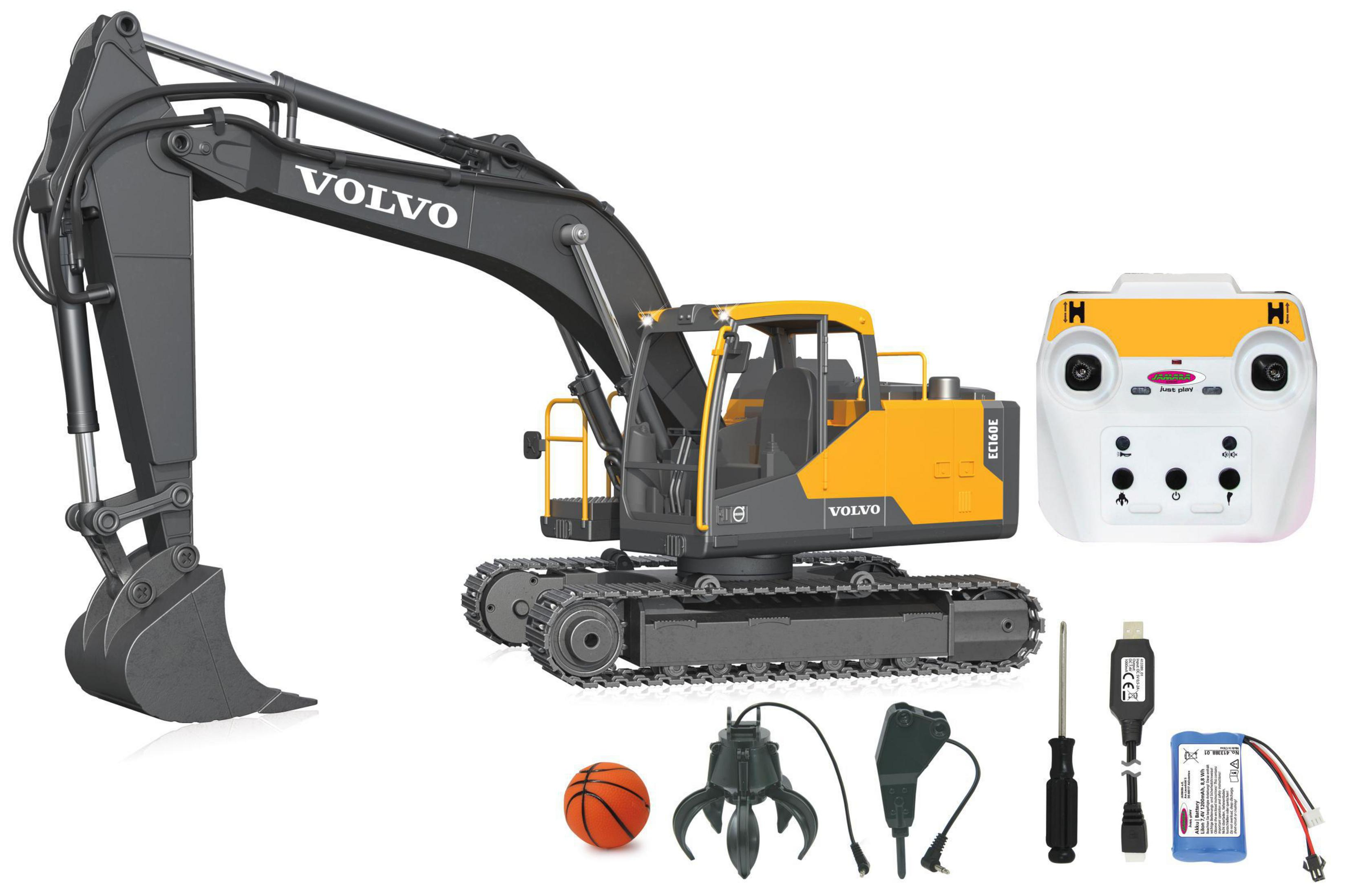 Gelb-graues Volvo-Bagger-Spielzeug mit Fernbedienung und Zubehör. Enthält einen Ball, einen Greifer und ein Ladegerät.
