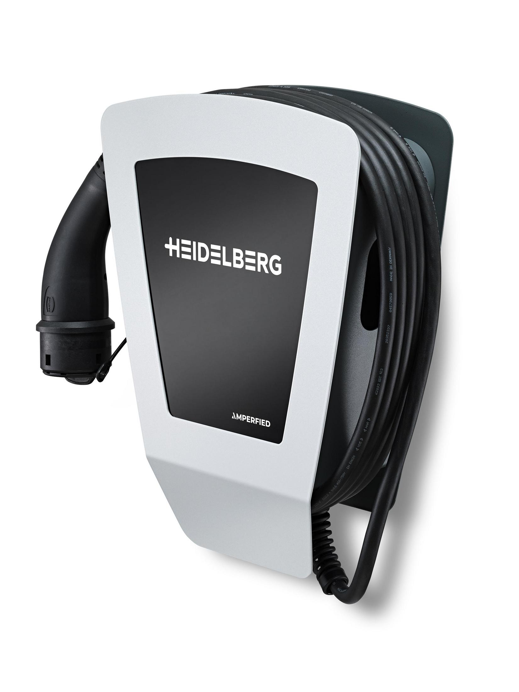 Ein weißes und schwarzes Ladegerät für Elektrofahrzeuge ist an einer Wand montiert. Es hat ein schwarzes Ladekabel.