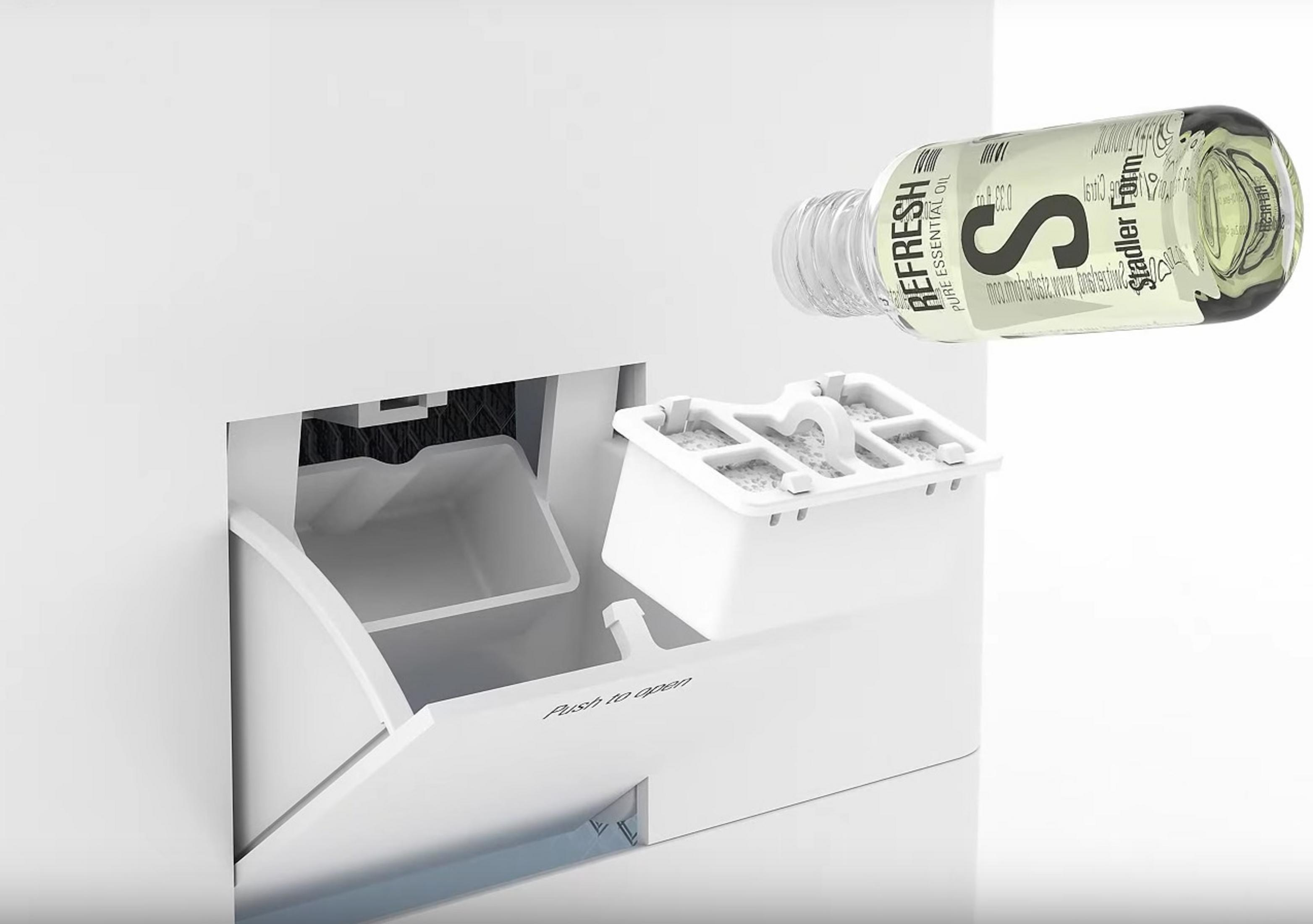 A white appliance with a bottle of essential oil, and a filter box.
