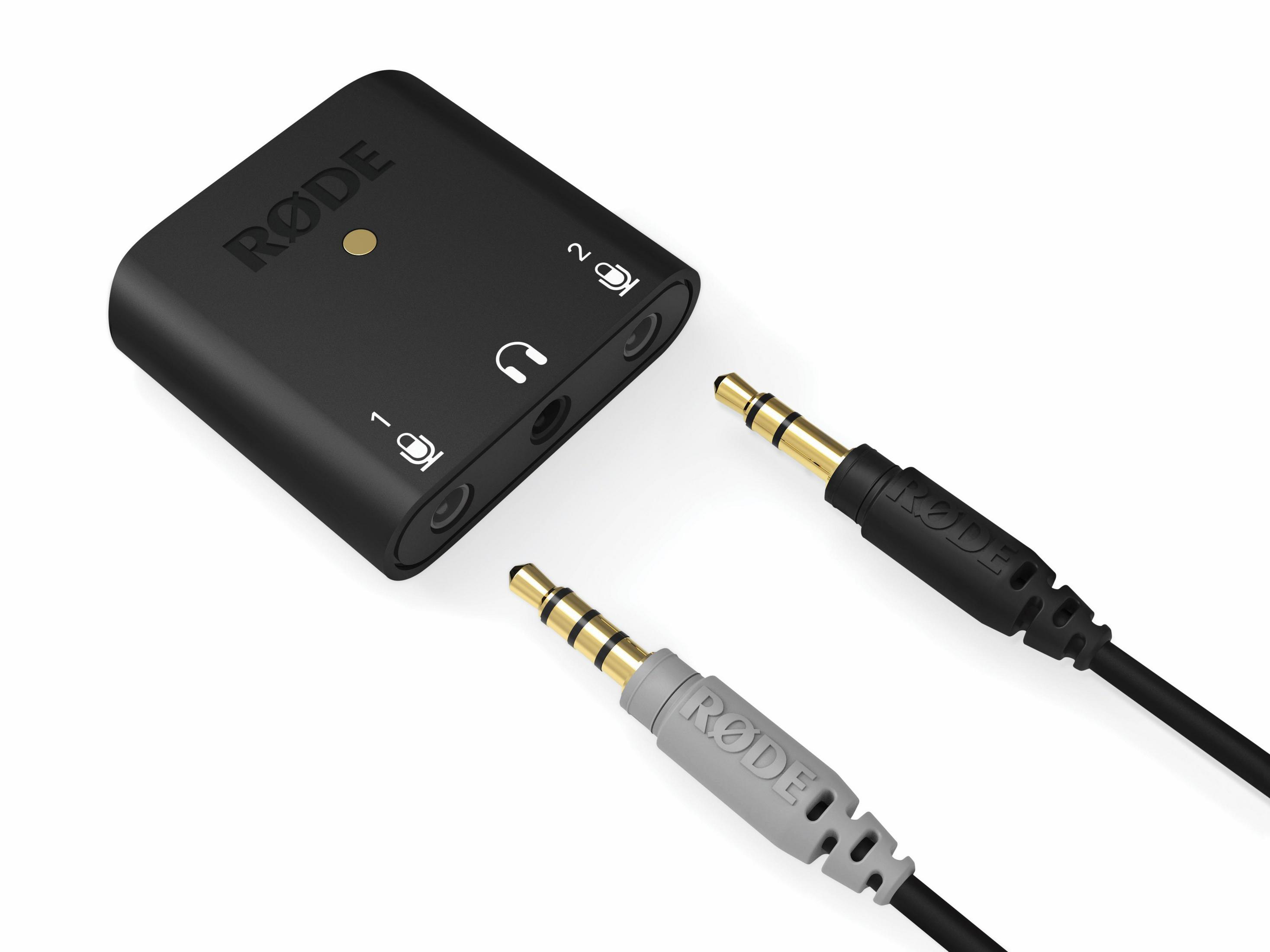 Zwarte audio-interface met twee kabels, één grijs en één zwart, en gouden connectoren op een witte achtergrond.