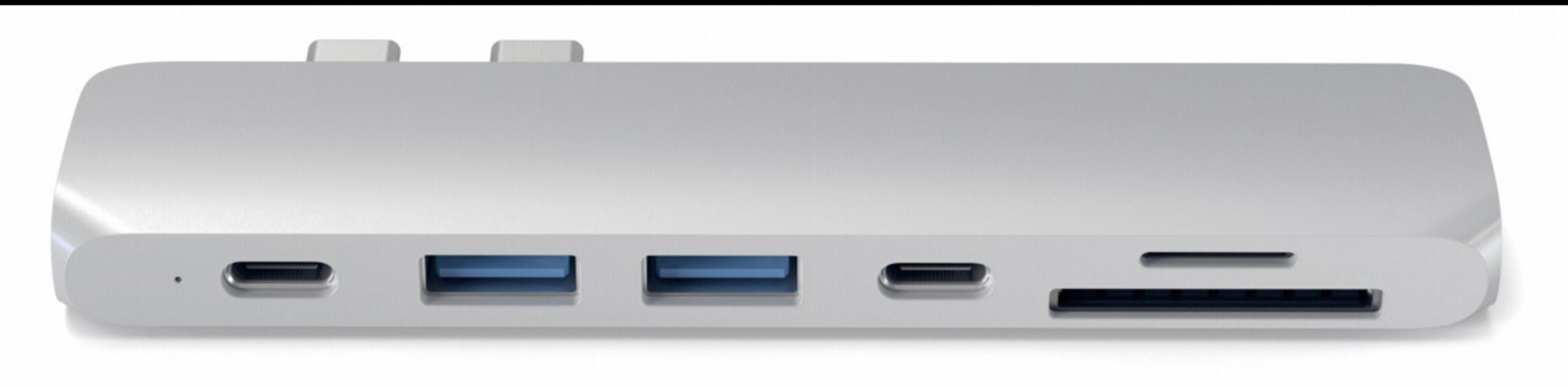 Silver multi-port adapter with USB and other ports.