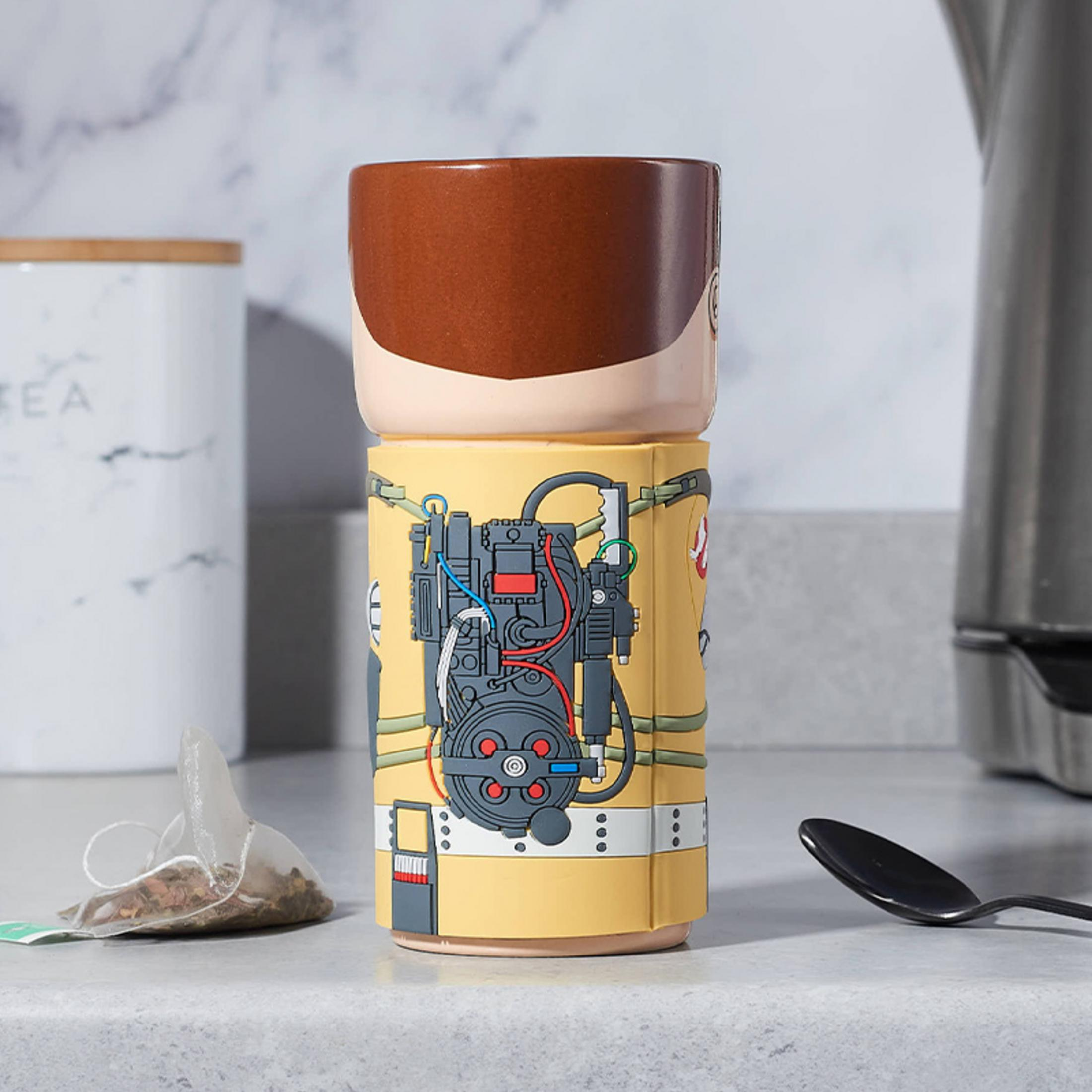 Eine Ghostbusters-Tasse mit braunem Kopf und gelbem Körper mit Protonenpack-Design.