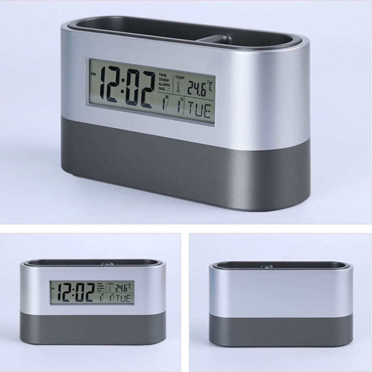 Eine digitale Uhr und ein Stifthalter in Silber und Dunkelgrau. Uhrzeit, Datum und Temperatur sind sichtbar.