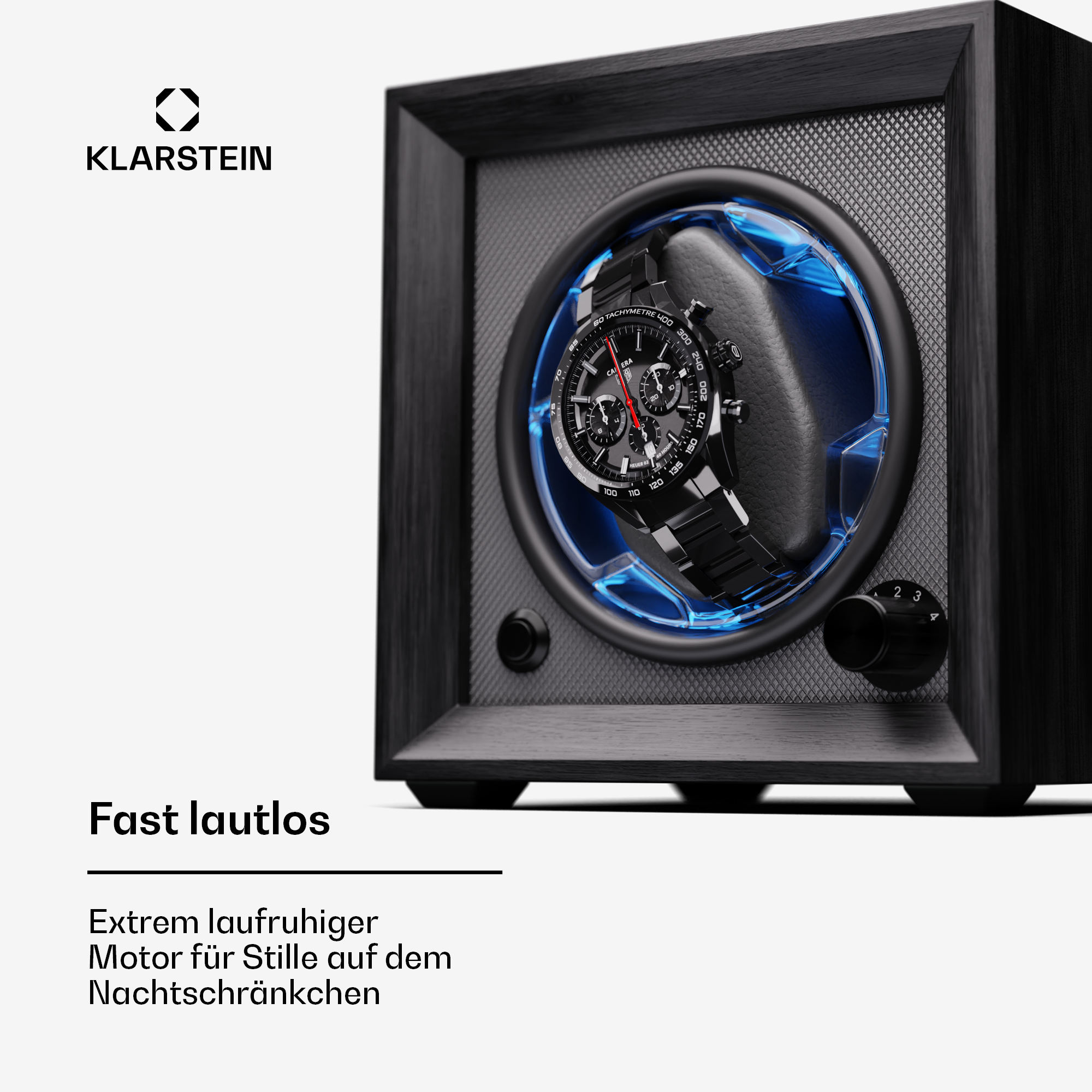 Schwarzer Uhrenbeweger mit einer Uhr darin, beleuchtet von blauen Lichtern. Schwarzer Hintergrund.