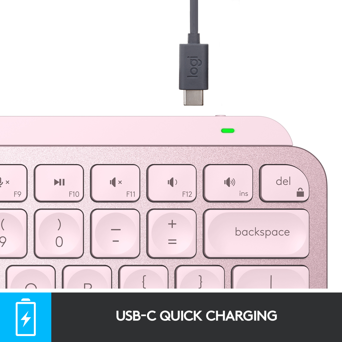 Różowa klawiatura z kablem USB-C. Klawiatura ma klawisze funkcyjne i klawisz backspace.