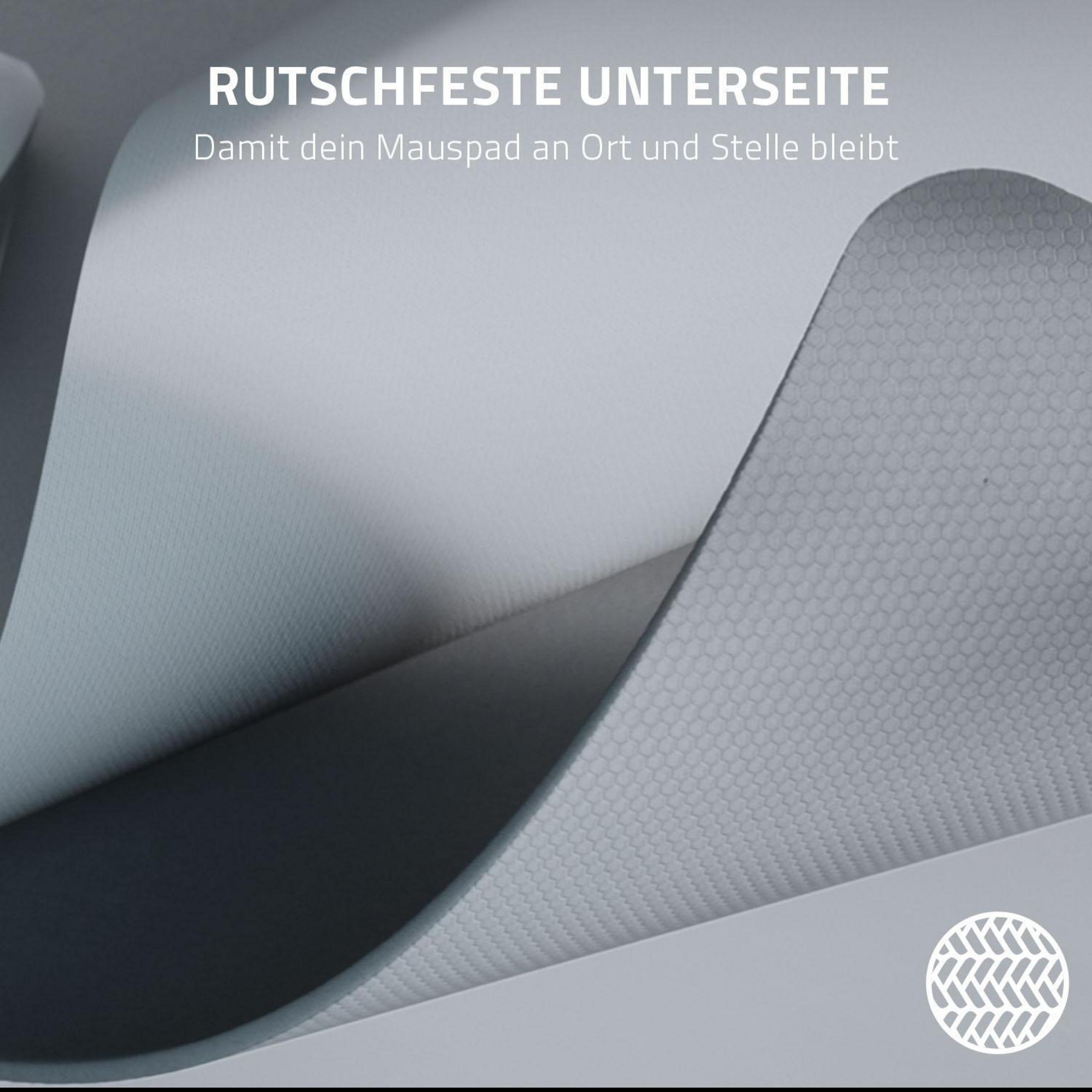 Zbliżenie szarej powierzchni podkładki pod mysz. Biały tekst brzmi: Antypoślizgowy spód, dzięki czemu podkładka pozostaje na miejscu.