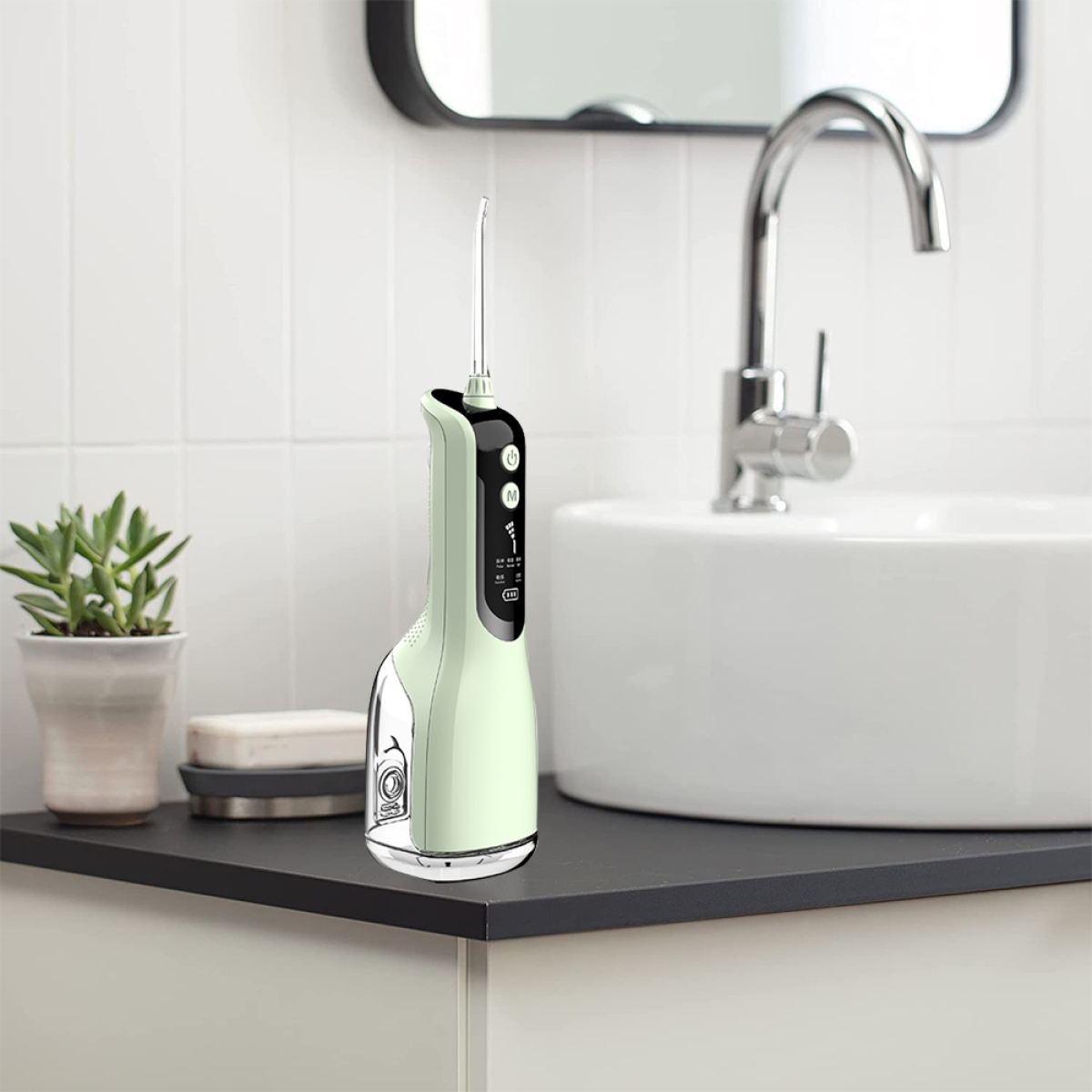 Ein weiß-grüner Wasserflosser auf einer schwarzen Theke neben Waschbecken und Spiegel.