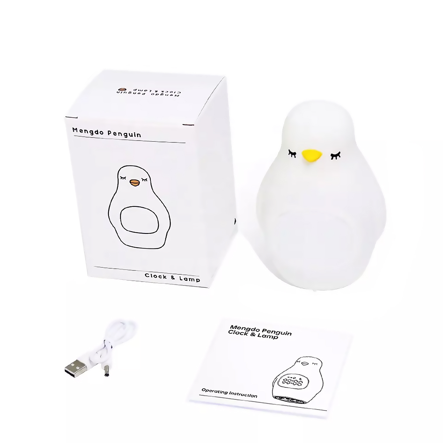 Luz de noche con forma de pingüino y su caja con instrucciones y un cable de carga.