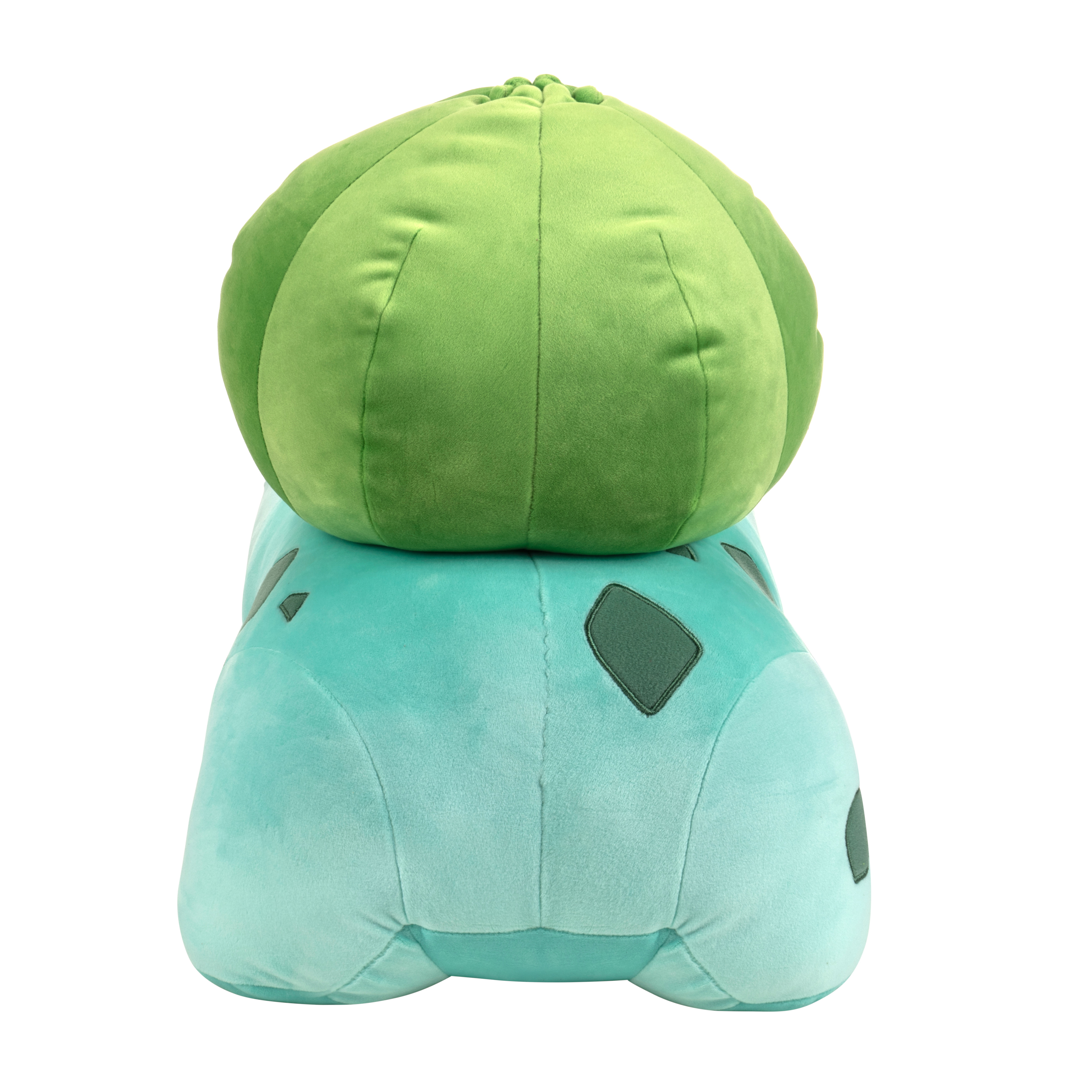 Ein Plüsch-Bulbasaur-Spielzeug. Grüner Körper mit einer großen grünen Knolle auf dem Rücken.