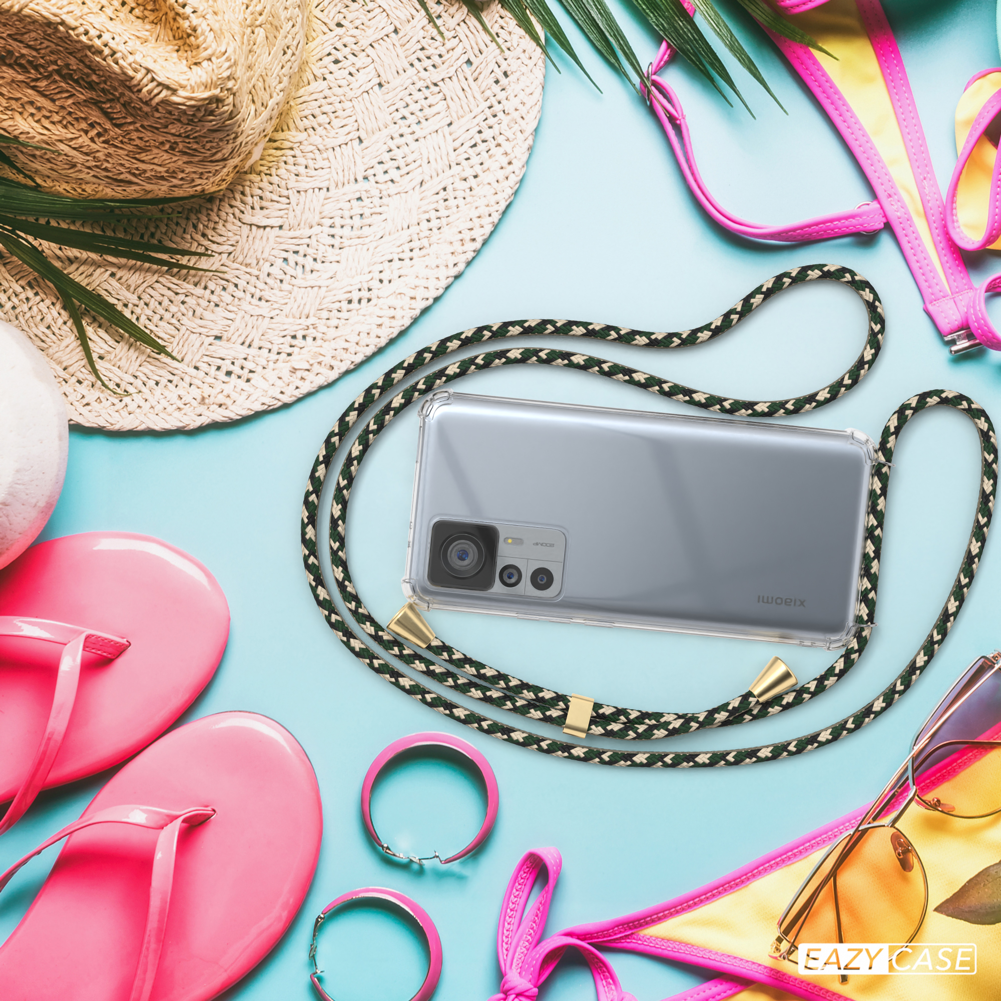 Telefon mit grün-schwarzem Band. Sonnenbrille und Hut auf blauem Hintergrund.
