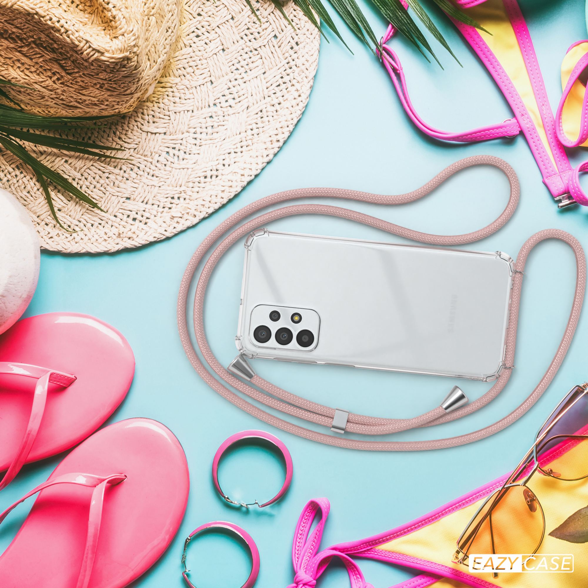 Strandszene mit Handyhülle und Accessoires. Das Telefon hat ein rosa Kabel.