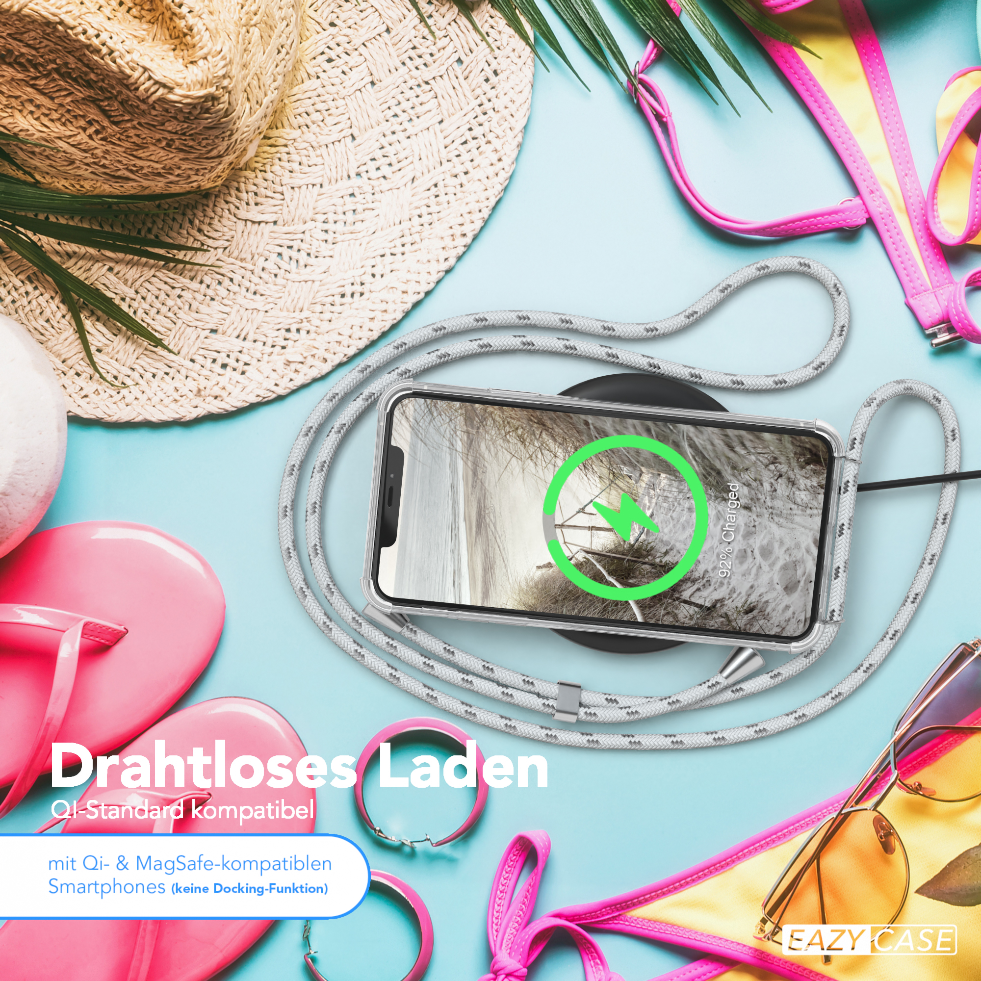 Telefon auf kabellosem Ladegerät. Ein pinker Bikini und andere Artikel im Hintergrund.