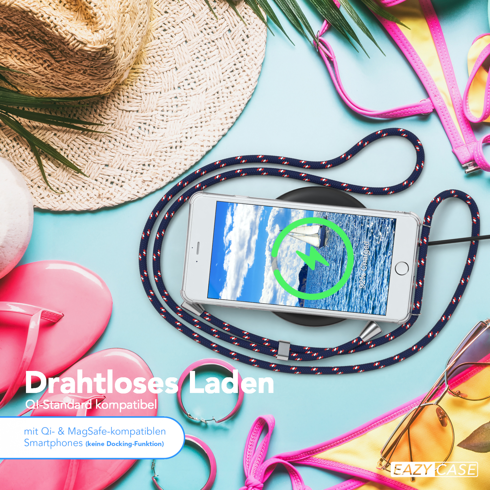 Ein Telefon auf einem kabellosen Ladegerät mit Strandaccessoires, einschließlich Hut und Sonnenbrille.