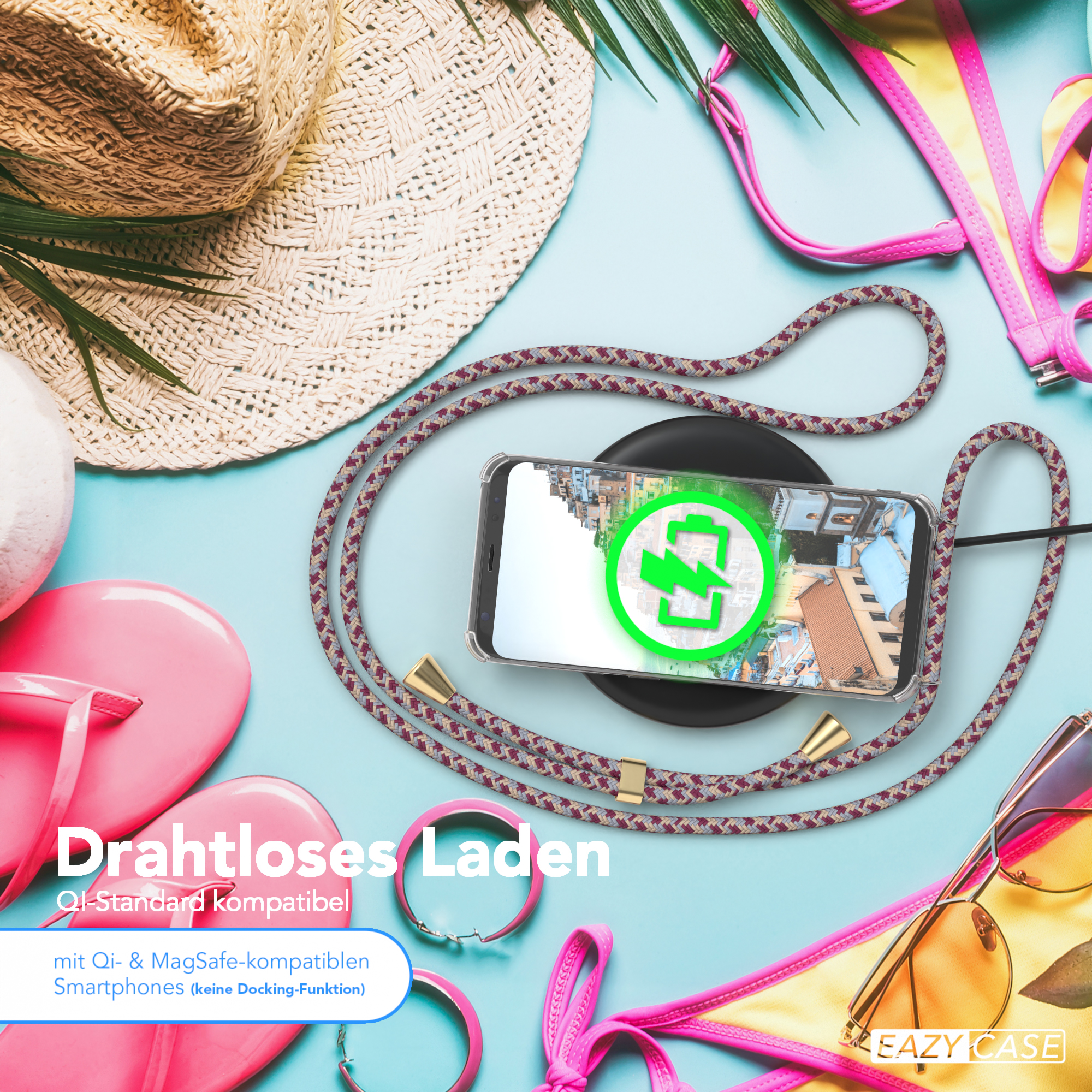 Telefon lädt auf kabellosem Ladegerät, umgeben von Strandaccessoires.