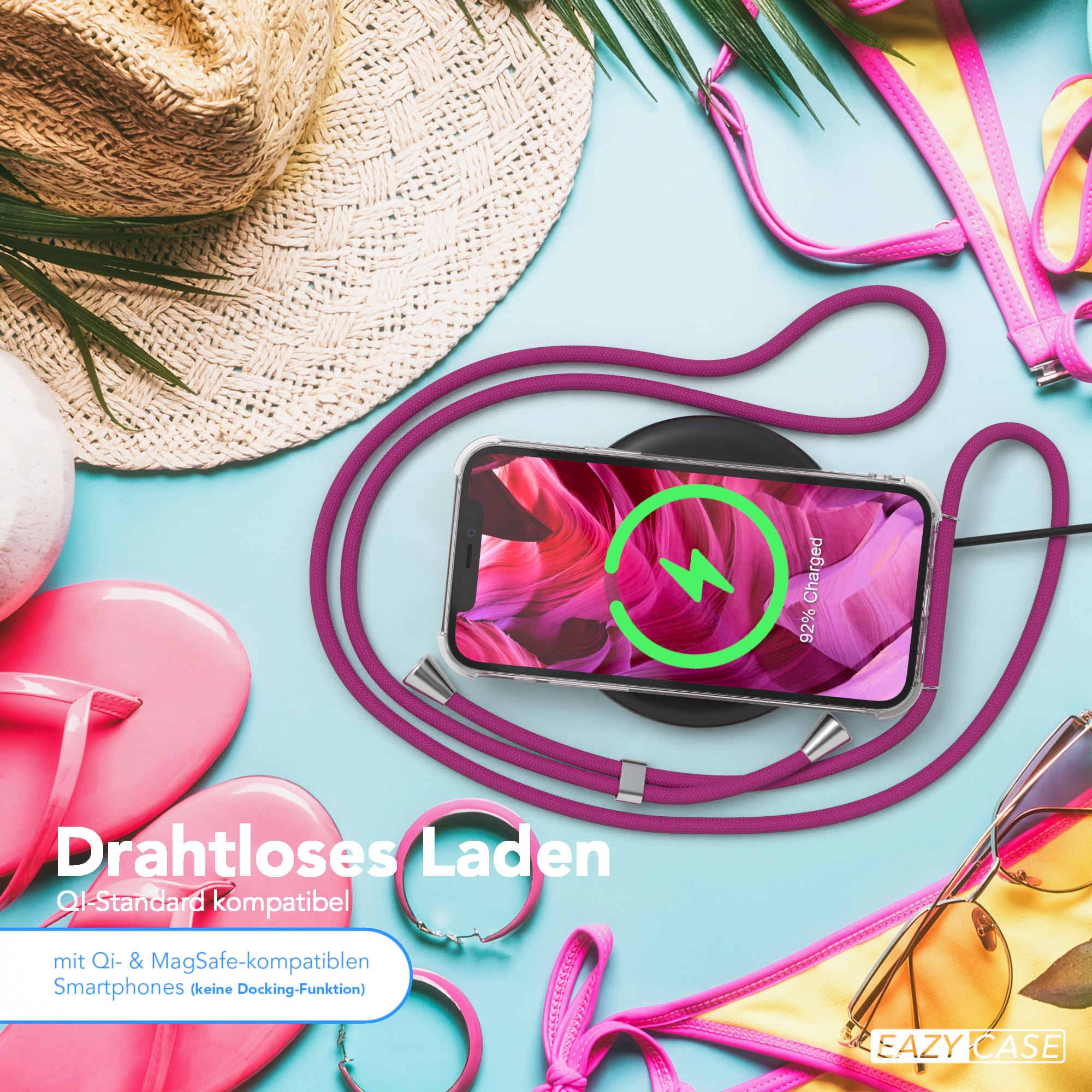 Telefon auf kabellosem Ladegerät, verbunden mit pinkfarbenem Riemen. Sonnenbrille und Strandaccessoires sind vorhanden.