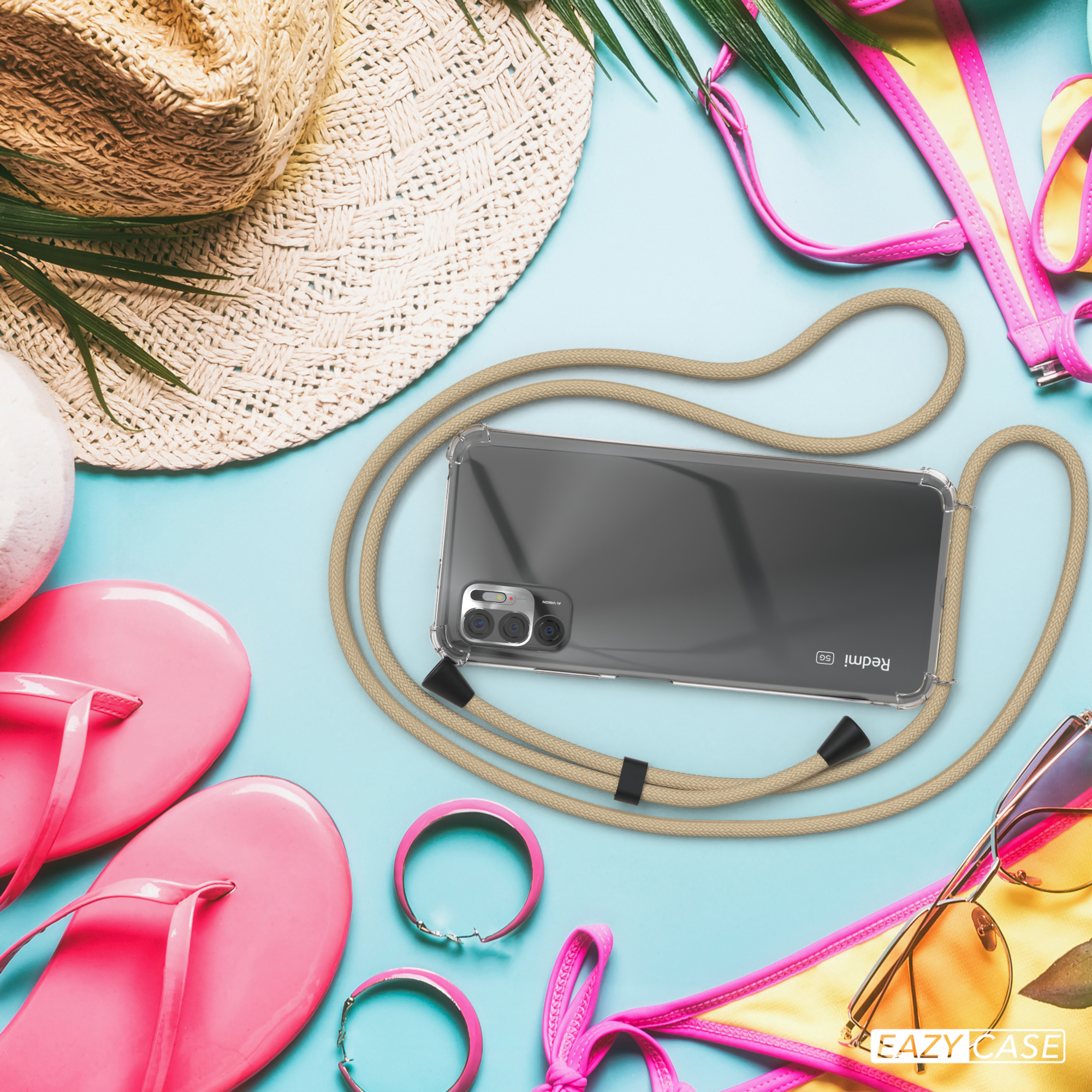 Telefon mit beiger Kordel am Strand mit Accessoires.