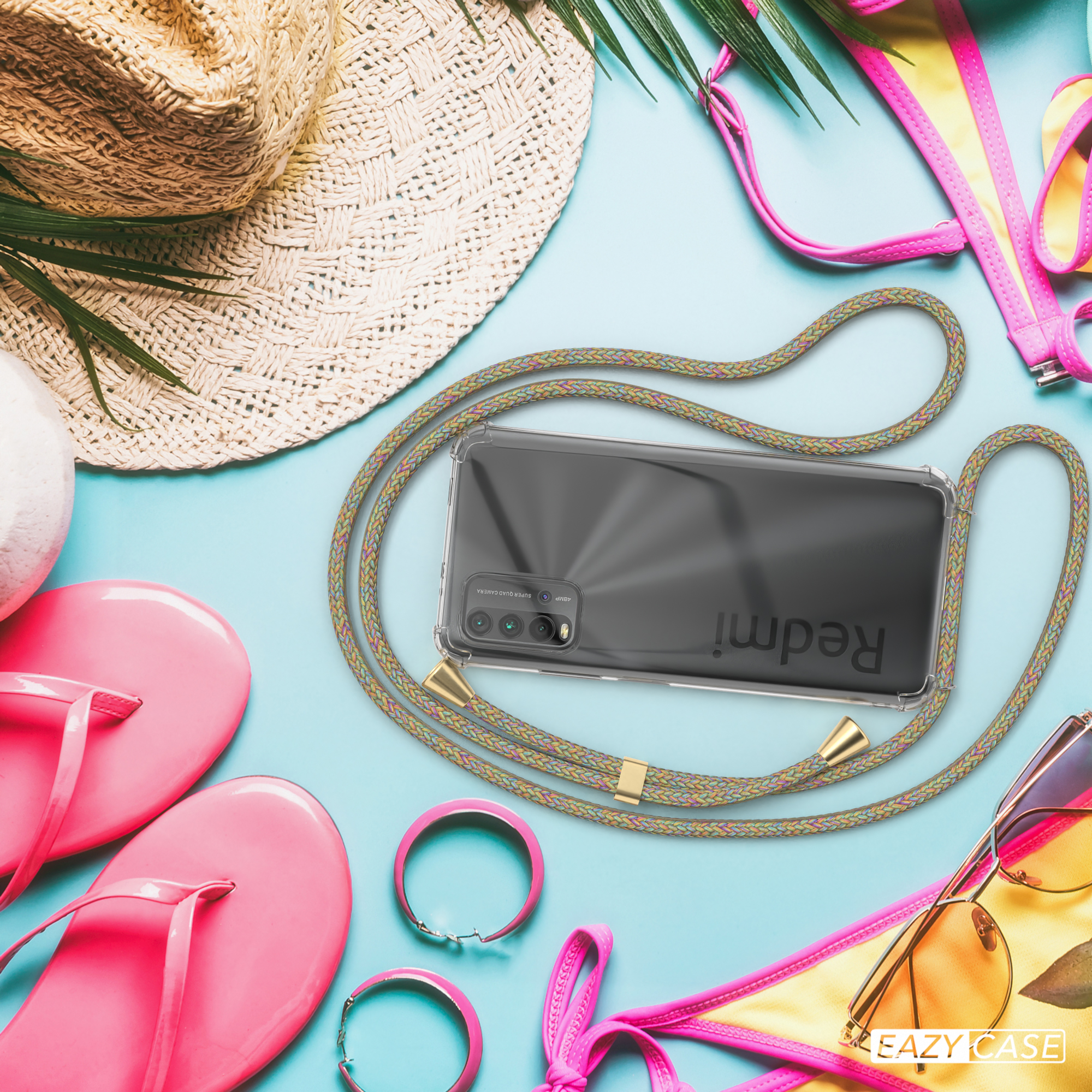 Telefon, das auf einer Matte mit einem grünen Energiesymbol geladen wird, umgeben von Hut, Sandalen, Sonnenbrille und Bikini.