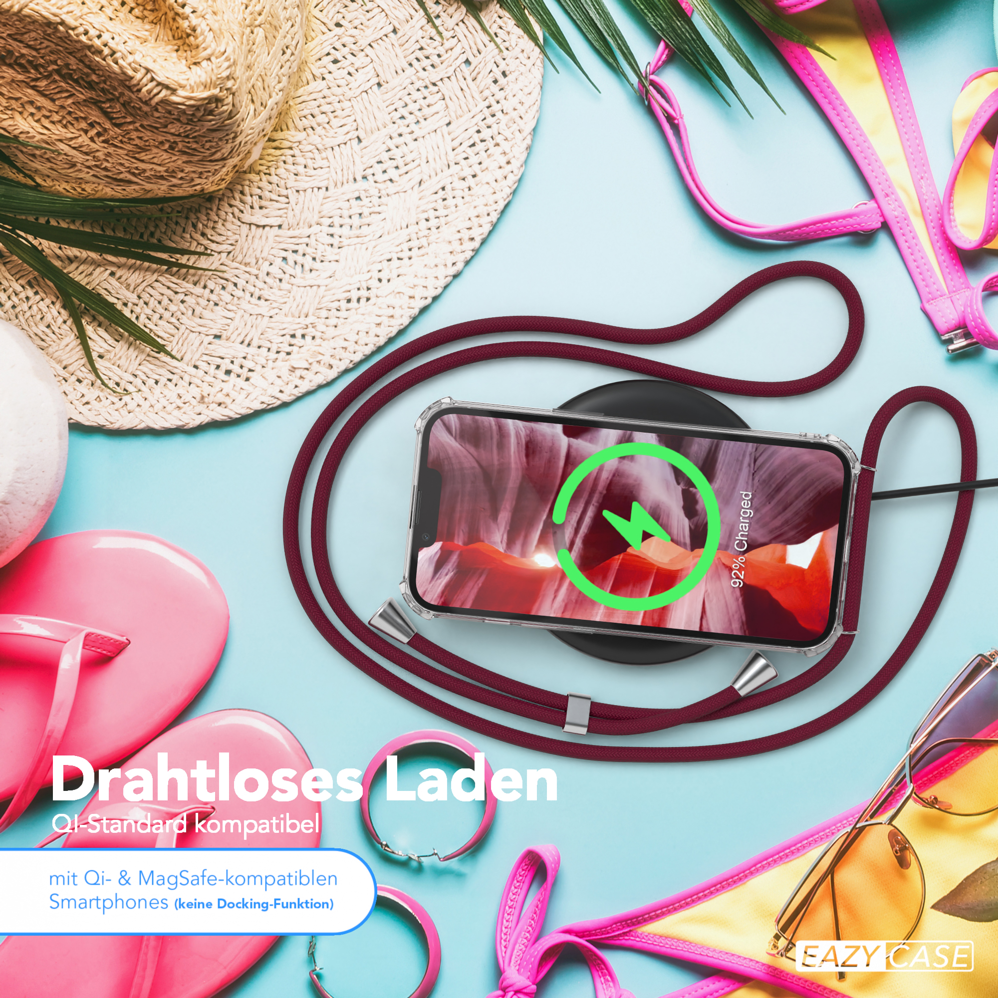 Telefon lädt kabellos, mit Strandaccessoires.