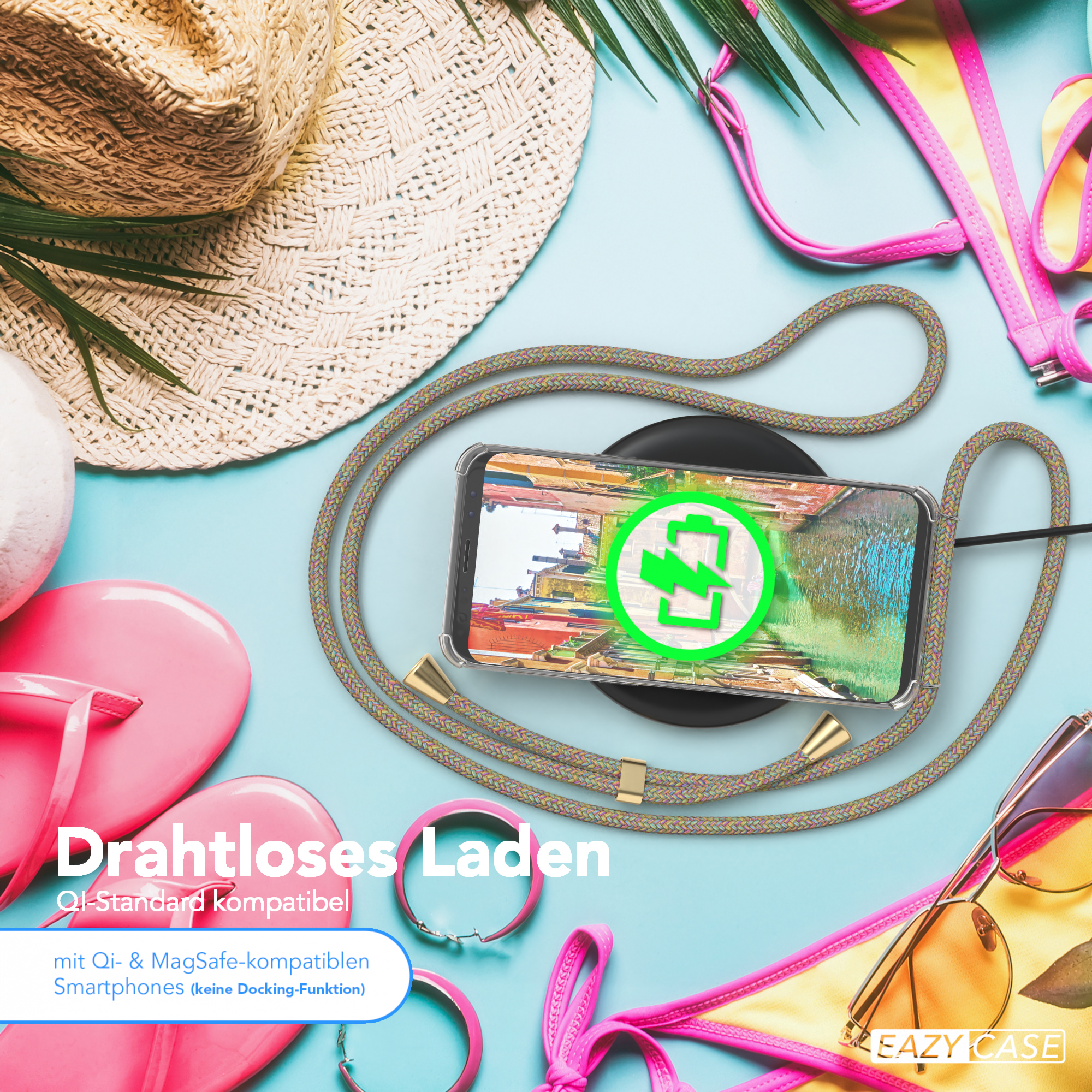 Telefon mit Hülle auf kabellosem Ladegerät, umgeben von Strandaccessoires.