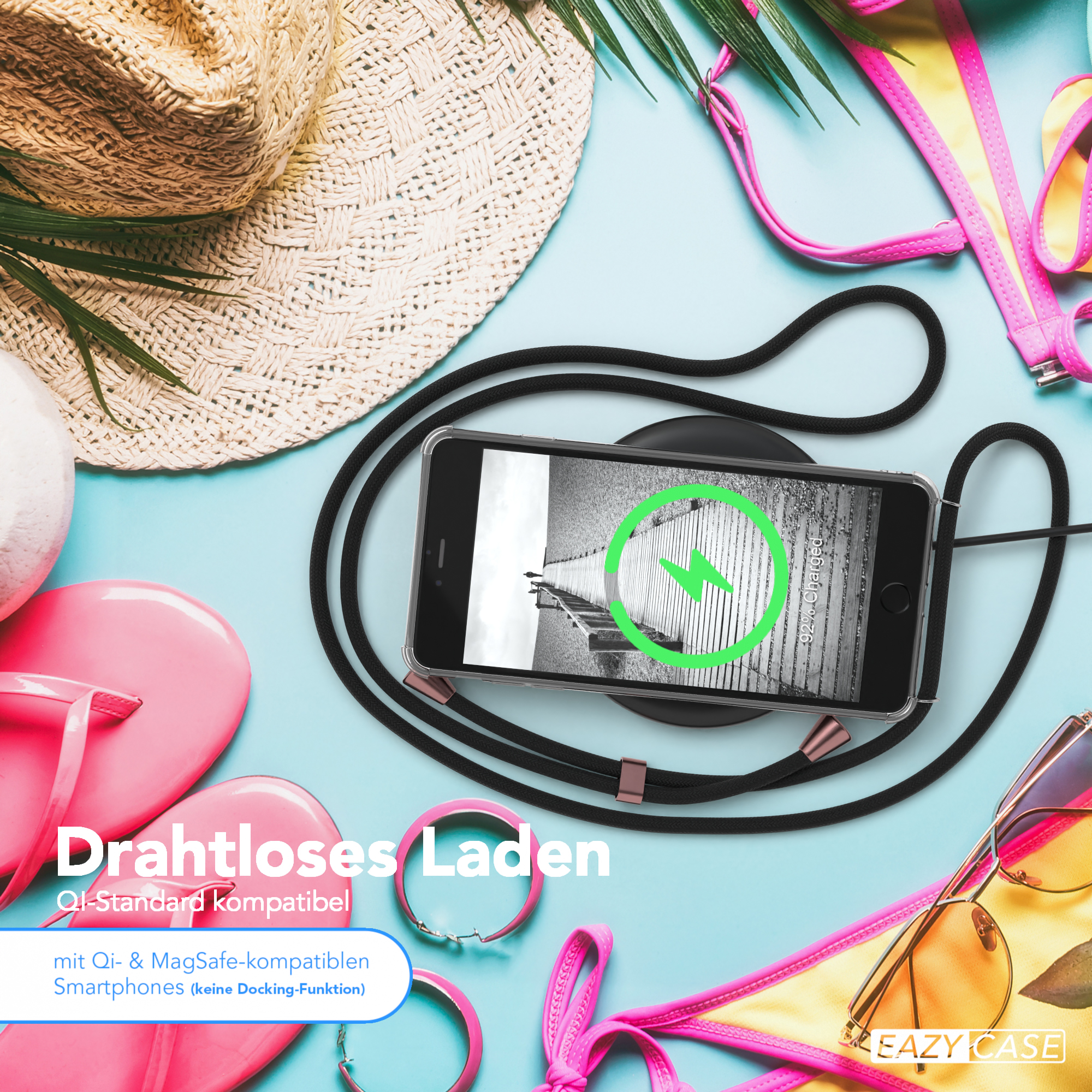 Telefon auf einem schwarzen kabellosen Ladegerät. Pinke Flip-Flops, Sonnenbrille und ein Bikini-Oberteil im Hintergrund.