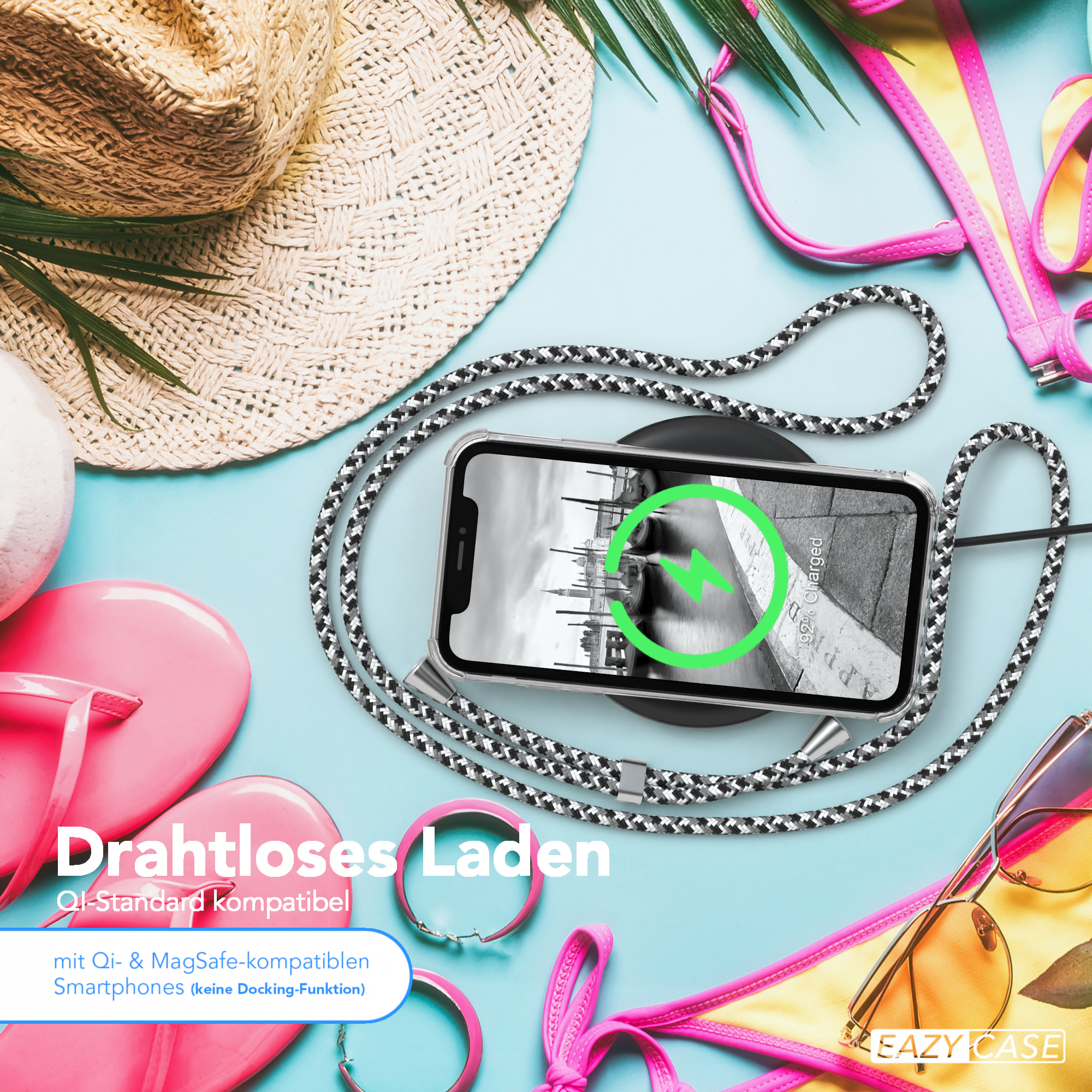 Telefon auf kabellosem Ladegerät, Strandszene mit Accessoires.