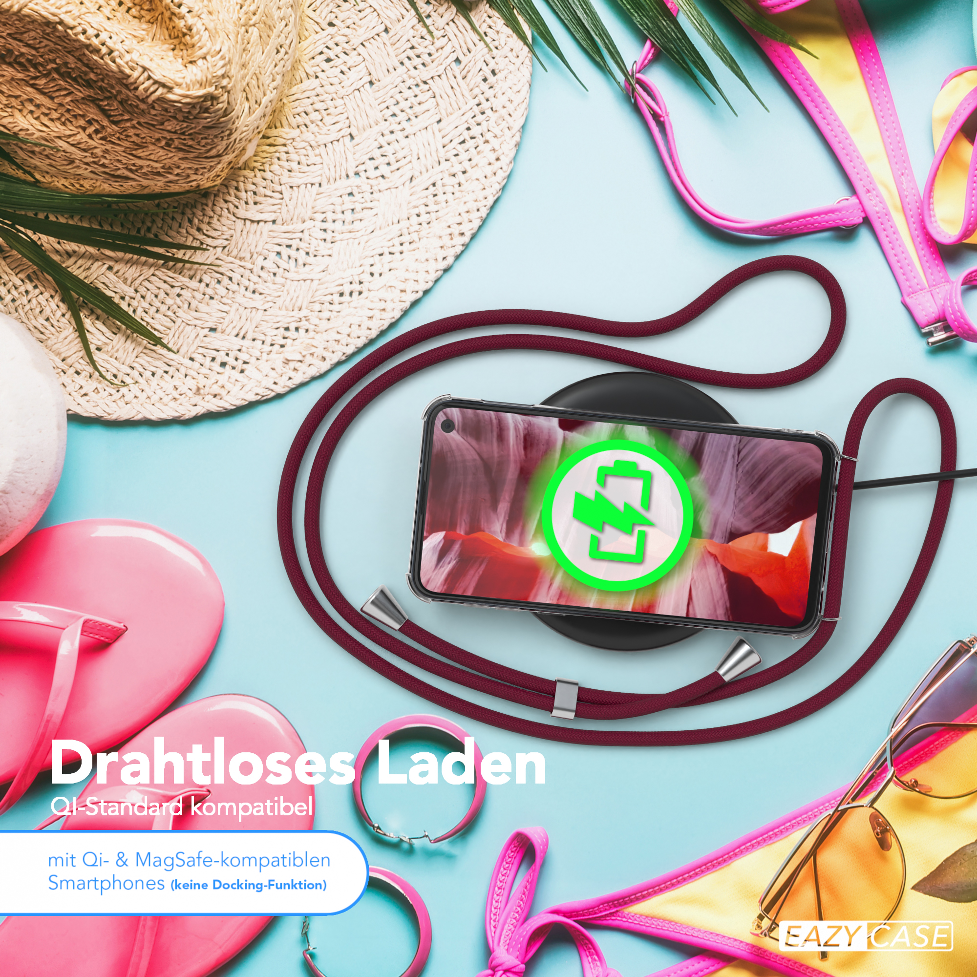 Telefon auf kabellosem Ladegerät mit rotem Ladekabel. Szene enthält Hut, Sonnenbrille und Bikini.