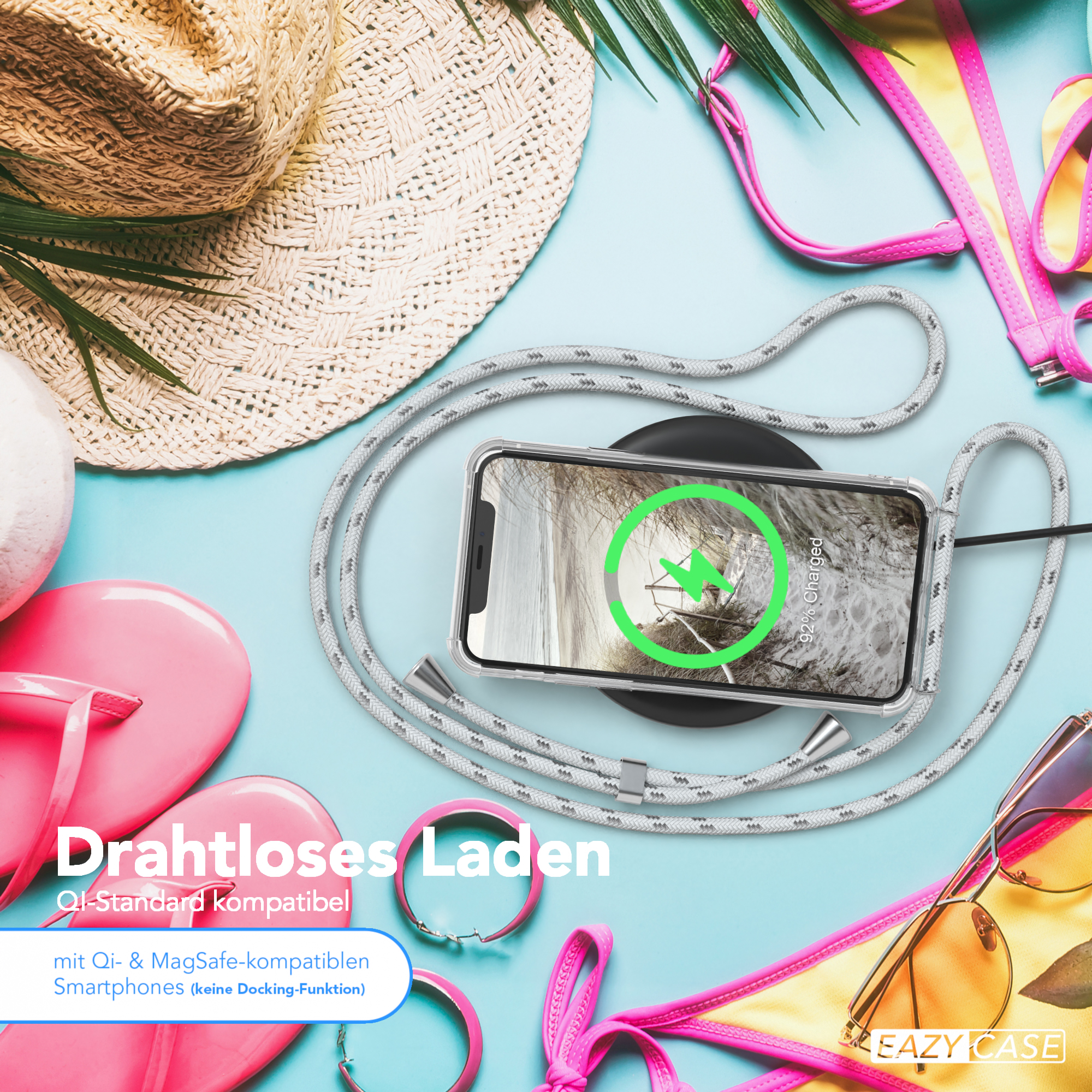 Telefon auf Ladepad mit grauem Kabel. Text: Drahtloses Laden. Strandartikel im Hintergrund. 92% geladen.