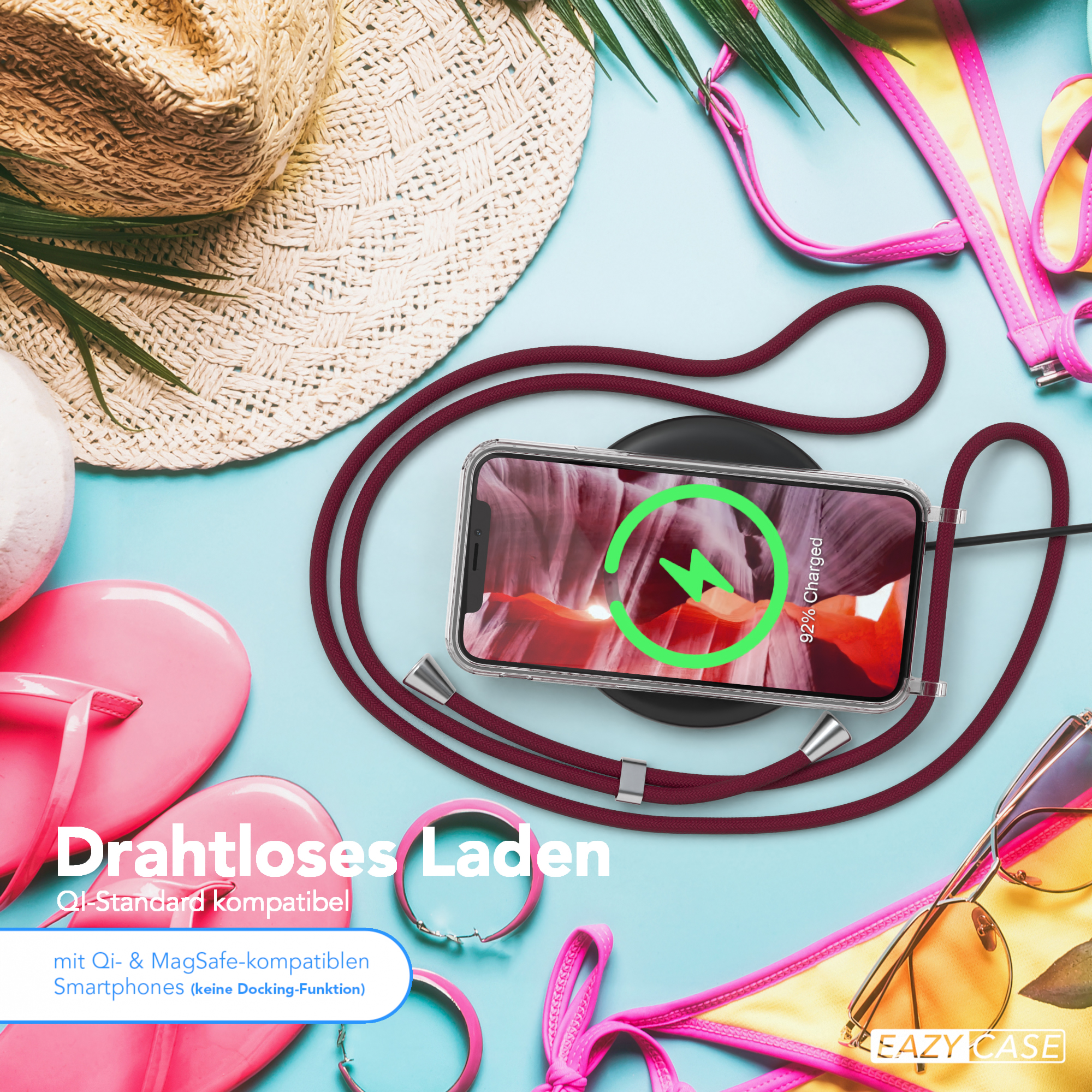 Telefon drahtlos auf einem Pad aufladen. Zubehör: Hut, Sonnenbrille, Flip-Flops.