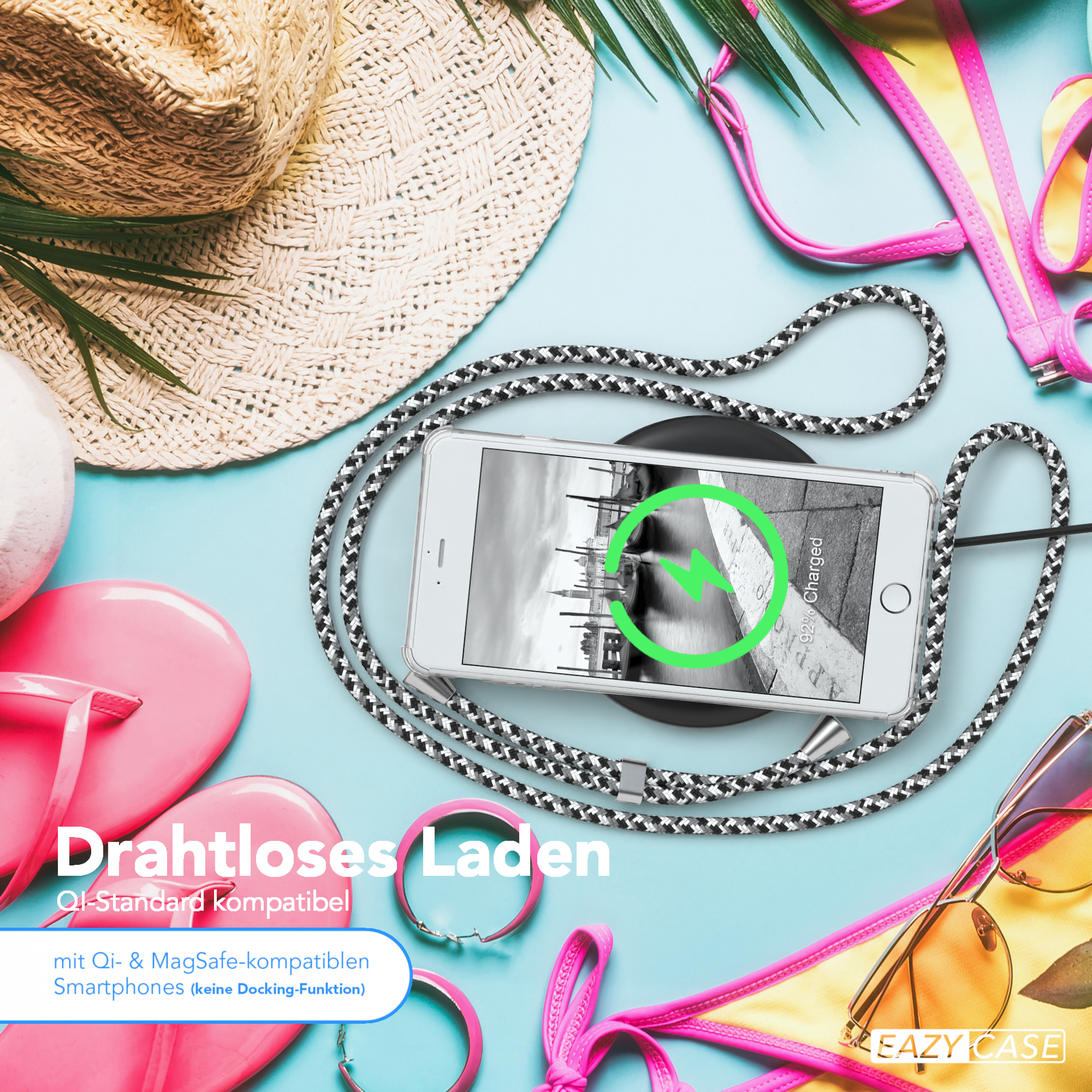 Telefon auf kabellosem Ladegerät, Strandaccessoires, Hut, Sonnenbrille und Text: Kabelloses Laden.